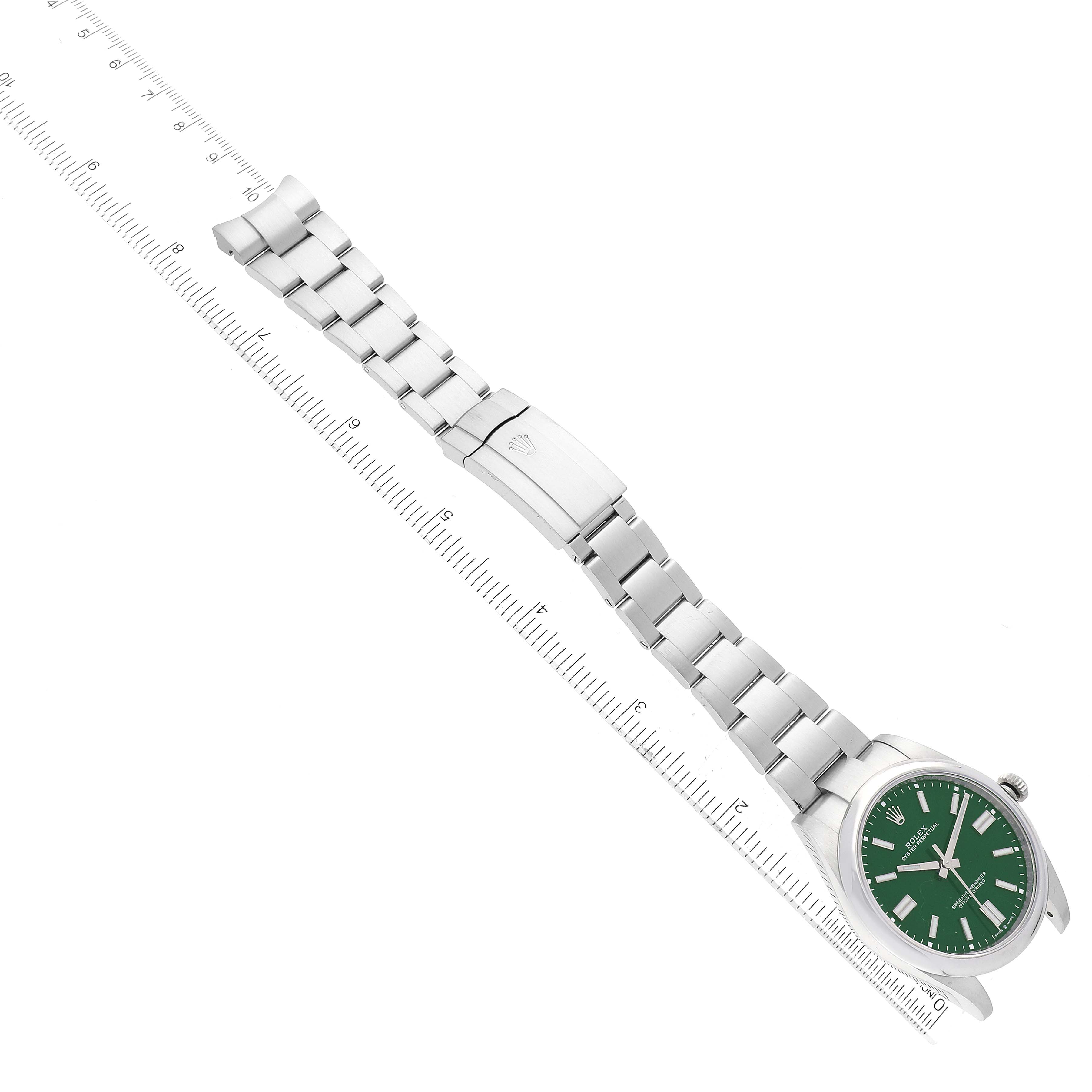 This image shows the full length of a Rolex Oyster Perpetual 124300 Men's Stainless Steel Green Dial 124300 Men's Stainless Steel Green Dial watch, including the bracelet, clasp, and green dial, placed alongside a ruler.