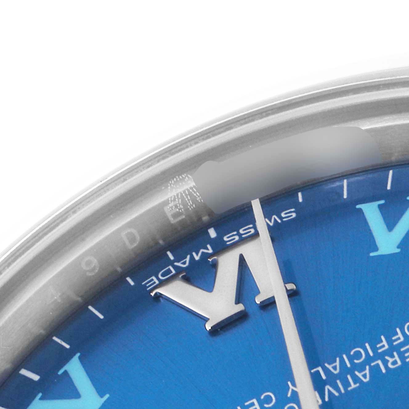 This image shows a close-up of the dial and bezel of a Rolex Mid-Size 177200 Women
s Stainless Steel Blue Dial 177200 Women
s Stainless Steel Blue Dial model watch, focusing on the 
VI
 hour marker and "Swiss Made" text.
