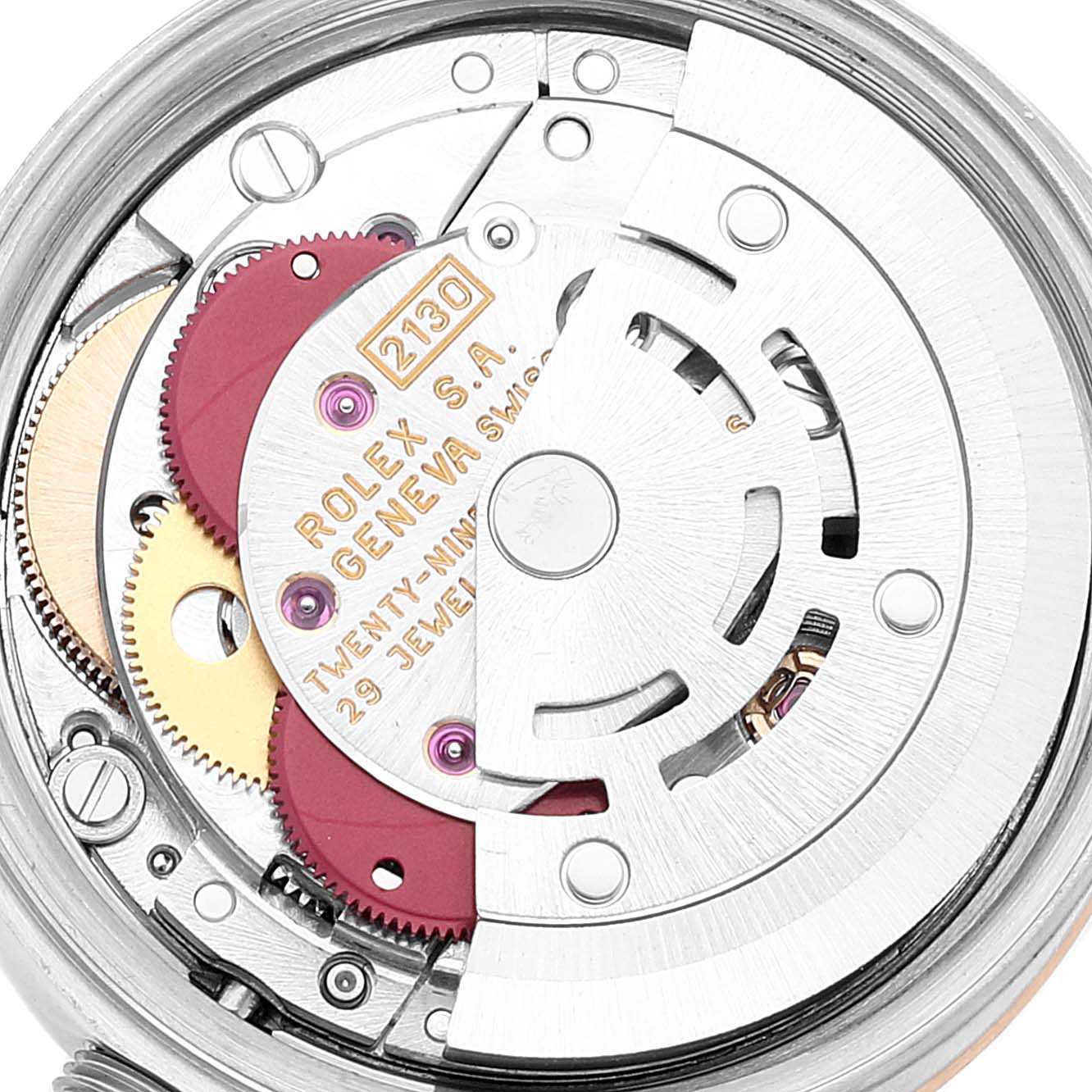 This is a close-up view of the movement mechanism of a Rolex Oyster Perpetual 67193 Women
s Steel and Gold (two tone) Champagne Dial 67193 Women
s Steel and Gold (two tone) Champagne Dial watch, showcasing the gears and inner workings.