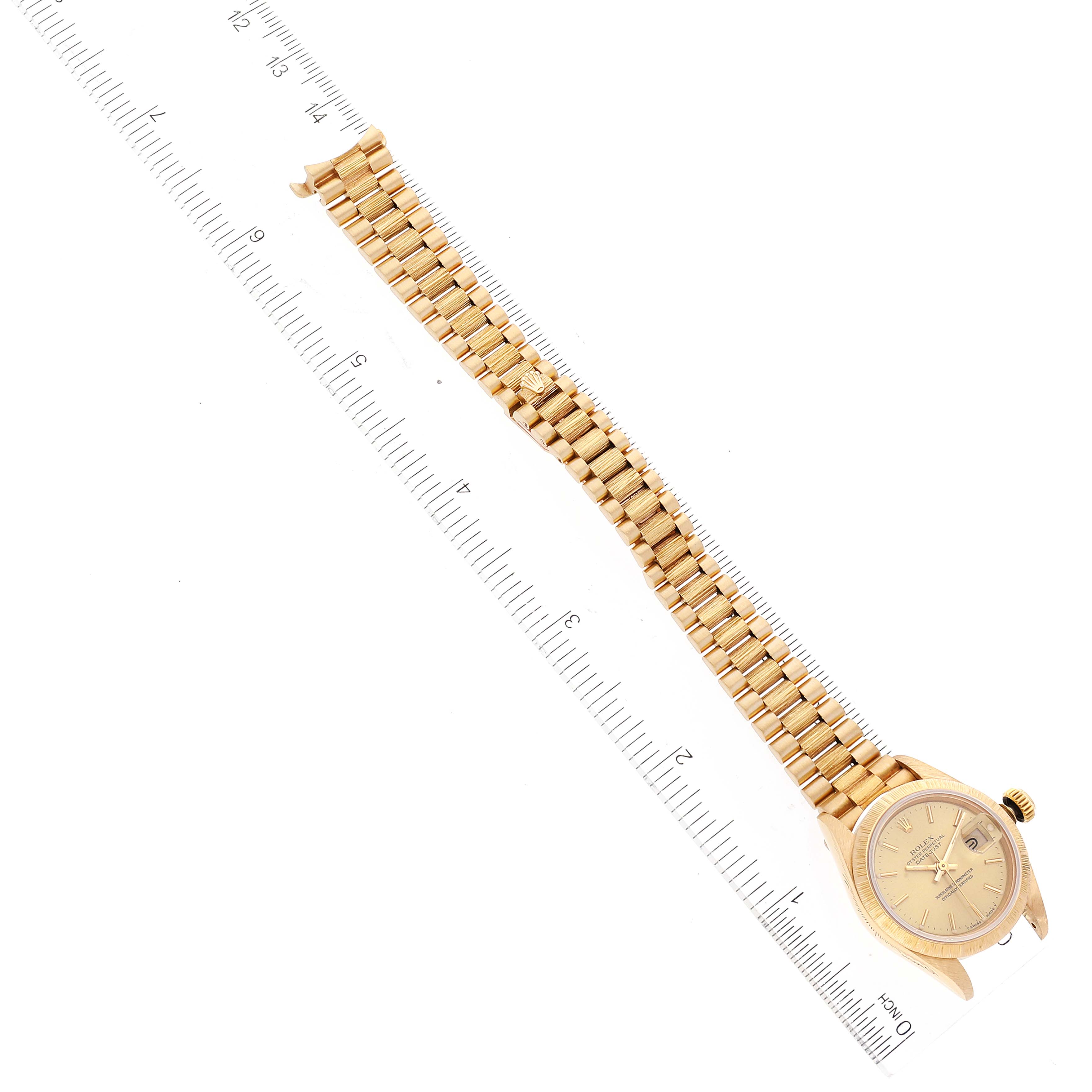 The image shows a top-down view of a Rolex President 69278 Women
s Yellow Gold Champagne Dial 69278 Women
s Yellow Gold Champagne Dial model watch, displaying the watch face and full bracelet alongside a ruler for scale.