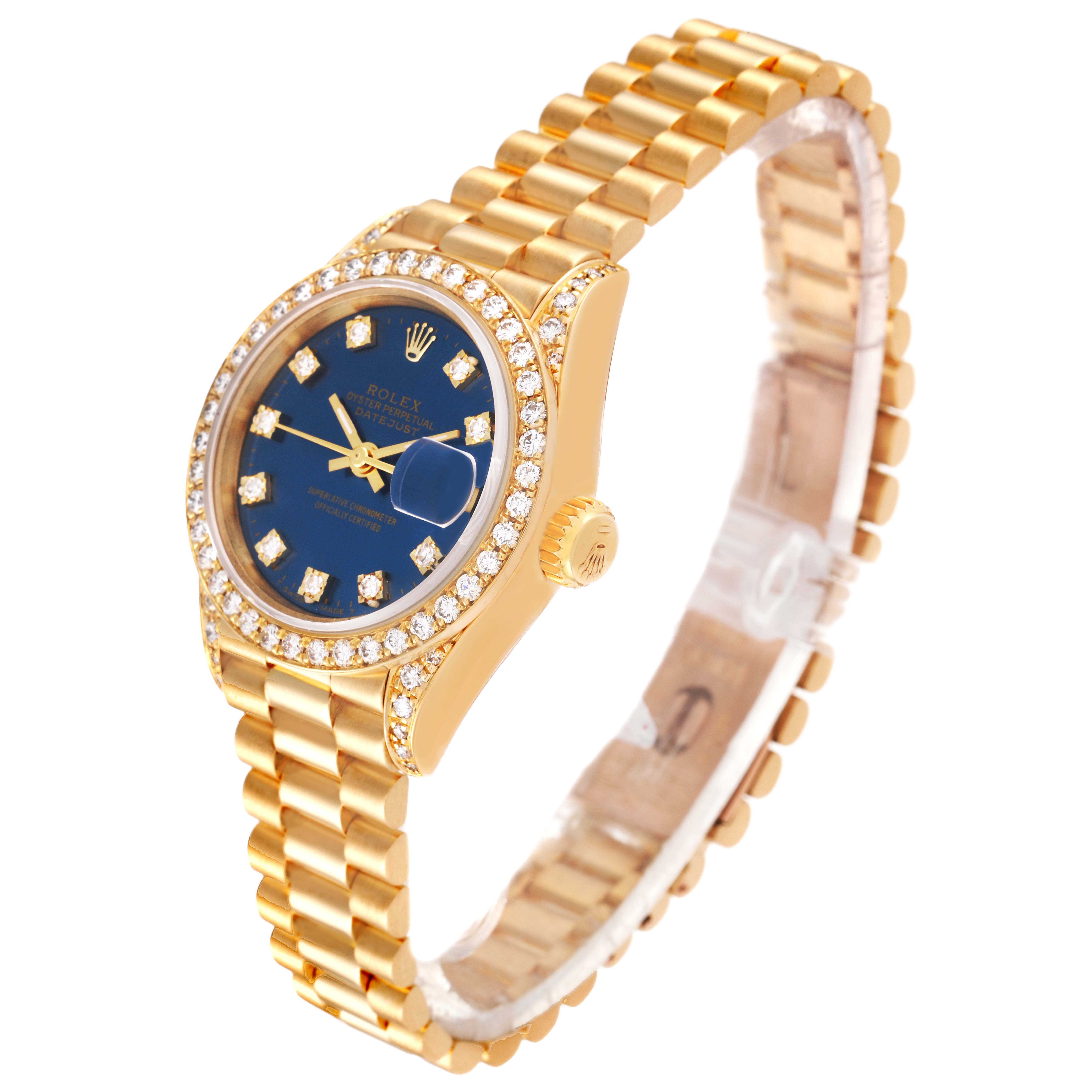 The image shows a Rolex President 69158 Women's Yellow Gold Blue Dial 69158 Women's Yellow Gold Blue Dial watch, angled to display its gold bracelet, blue dial, diamond bezel, and crown.