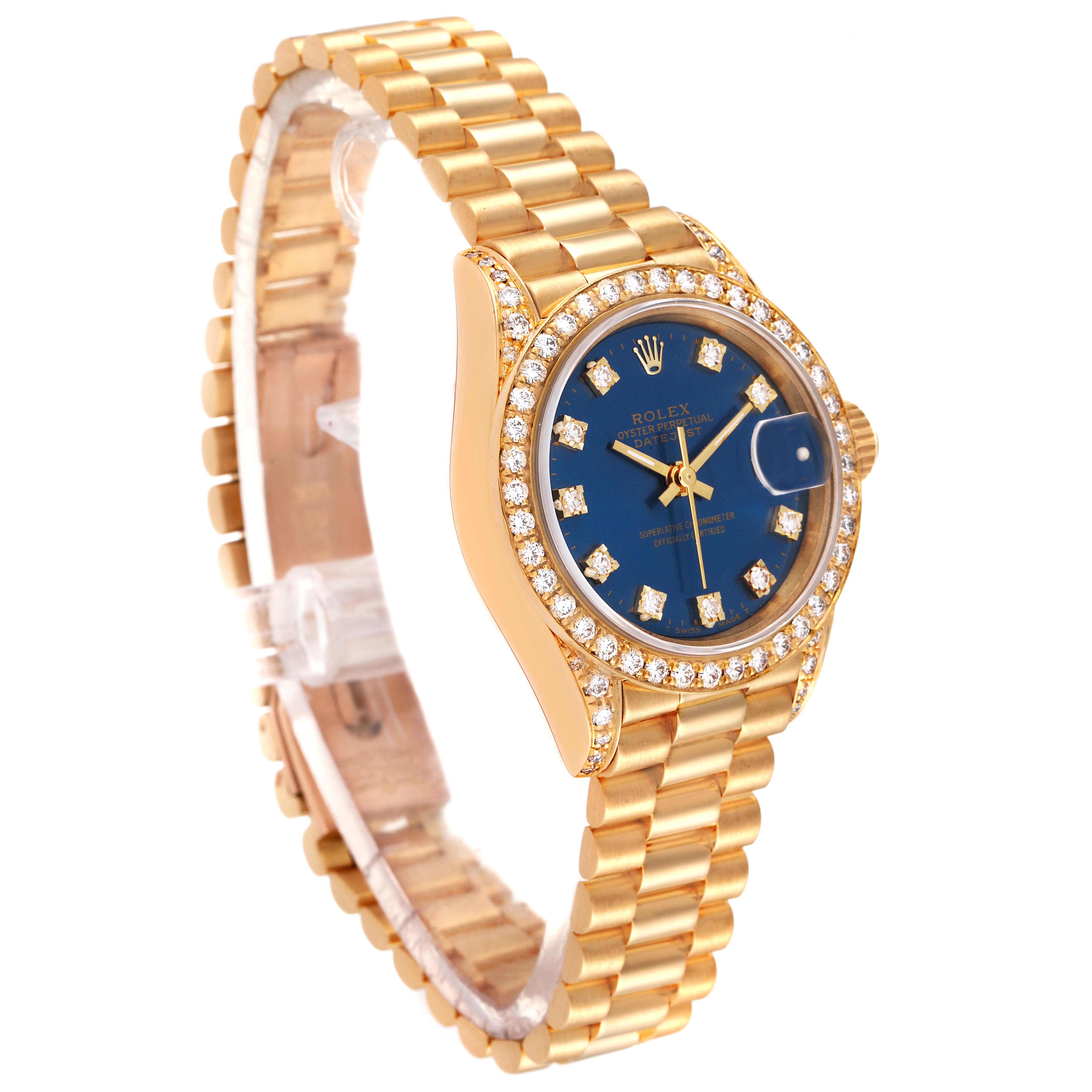 The Rolex President 69158 Women's Yellow Gold Blue Dial 69158 Women's Yellow Gold Blue Dial model watch is shown at a slight angle, highlighting its gold band, blue dial, and diamond-encrusted bezel.