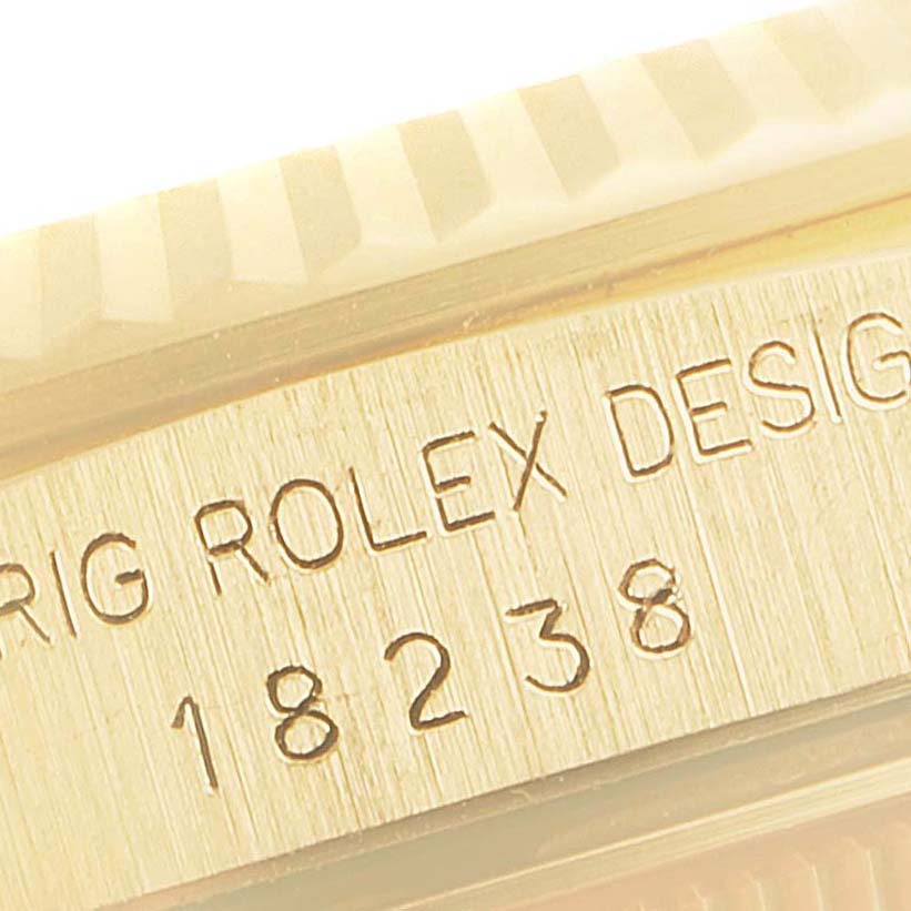 This image shows an angled close-up of the engraved serial numbers on the case edge of a Rolex President 18238 Men's Yellow Gold Champagne Dial 18238 Men's Yellow Gold Champagne Dial model 18238.