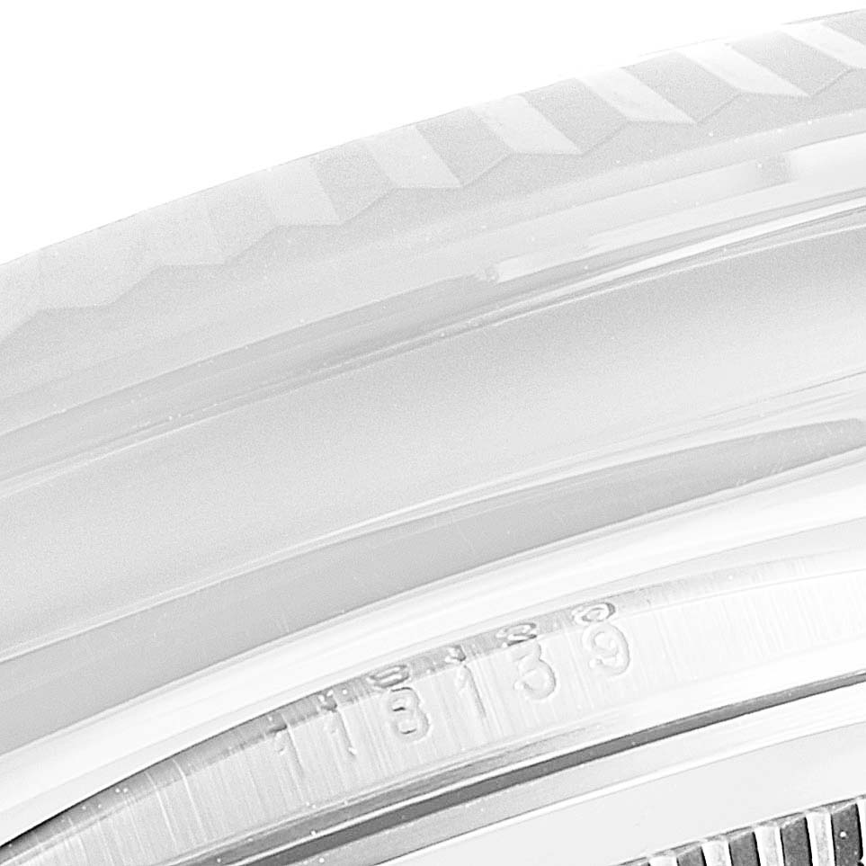 This close-up angle of the Rolex President 118139 Men's Stainless Steel Blue Dial 118139 Men's Stainless Steel Blue Dial model shows part of the bezel and the case, highlighting some serial numbers.