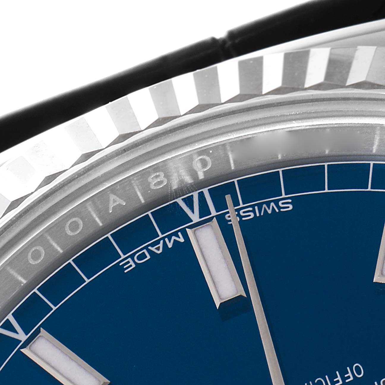 The image shows a close-up angle of the Rolex President 118139 Men's Stainless Steel Blue Dial 118139 Men's Stainless Steel Blue Dial model's bezel and part of its blue dial with Roman numeral VI and "SWISS MADE" text.