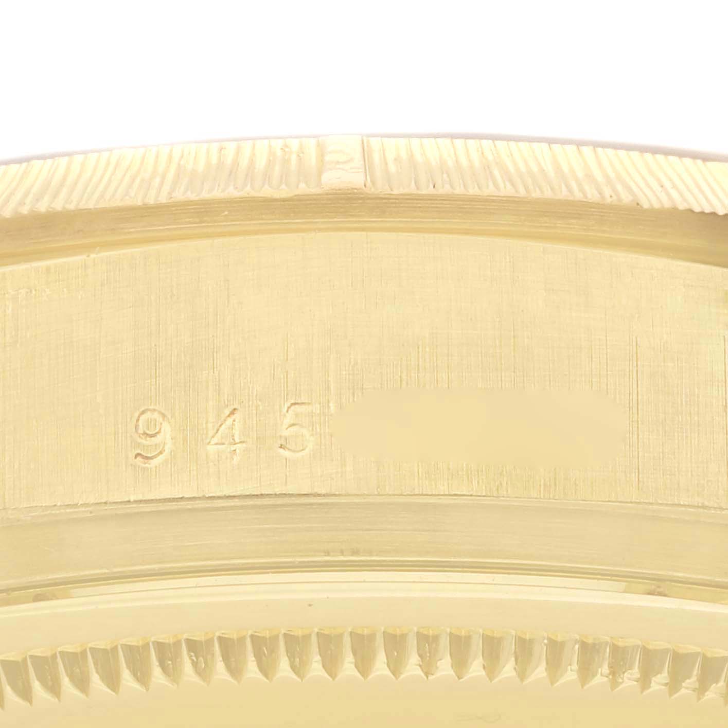 Close-up of the side of a Rolex President 18078 Men
s Yellow Gold Black Dial 18078 Men
s Yellow Gold Black Dial watch case, showing part of the bezel and engraved numbers.