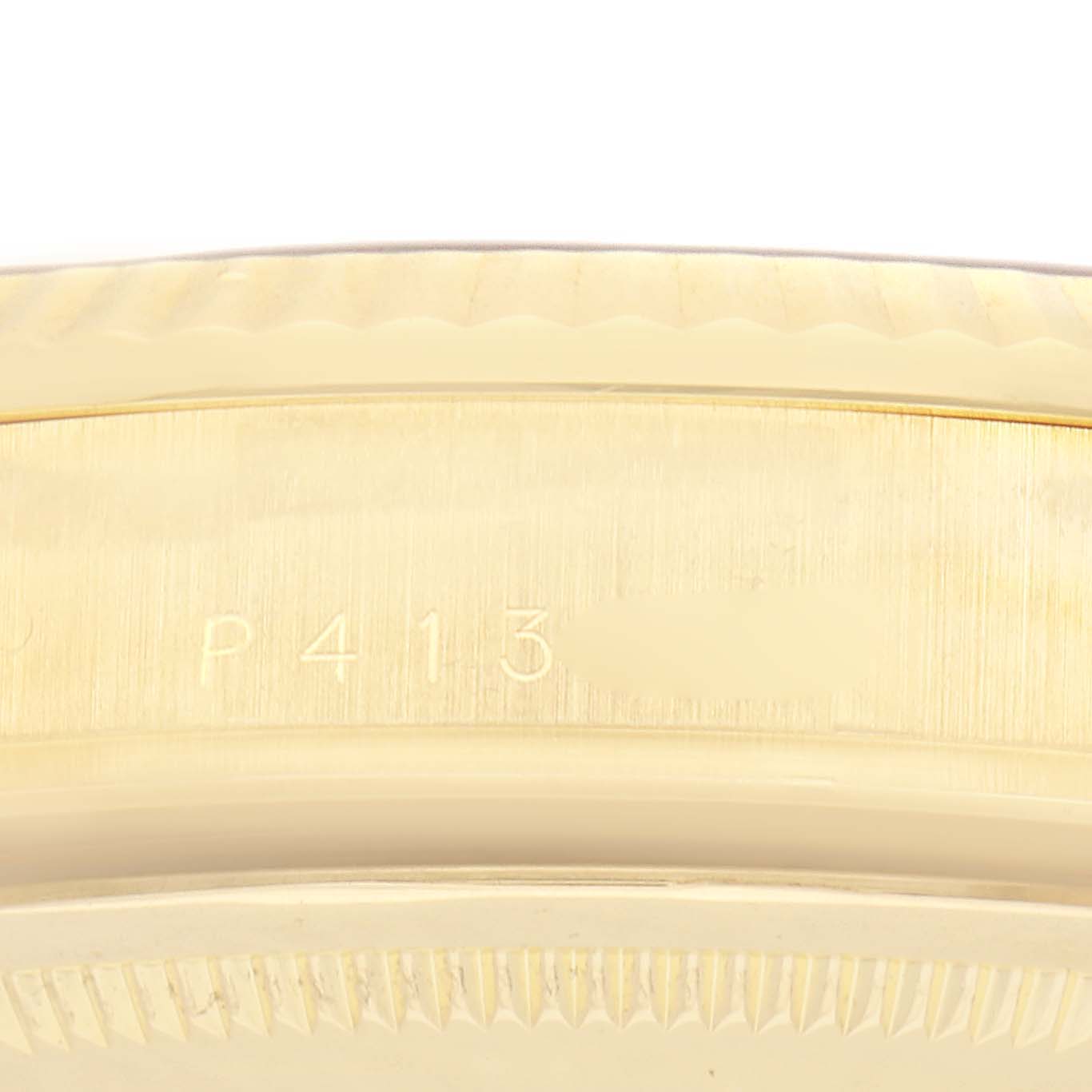 The image shows a close-up of the engraved side of the bezel on a Rolex President 118238 Men
s Yellow Gold Blue Dial 118238 Men
s Yellow Gold Blue Dial watch.