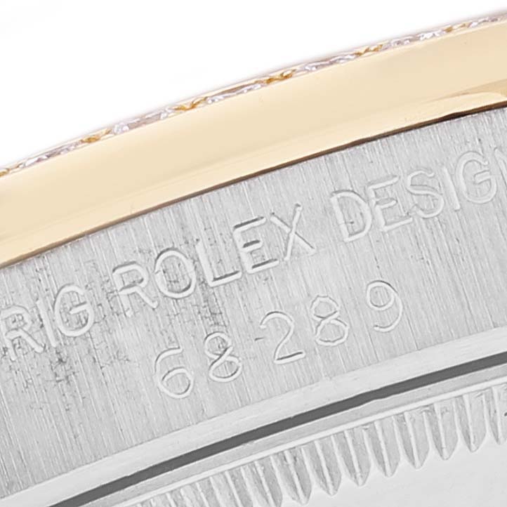This close-up image shows the side of the Rolex President 68289 Women's Steel and Gold (two tone) Brown Dial 68289 Women's Steel and Gold (two tone) Brown Dial model, featuring the engraved model number and part of the bezel.