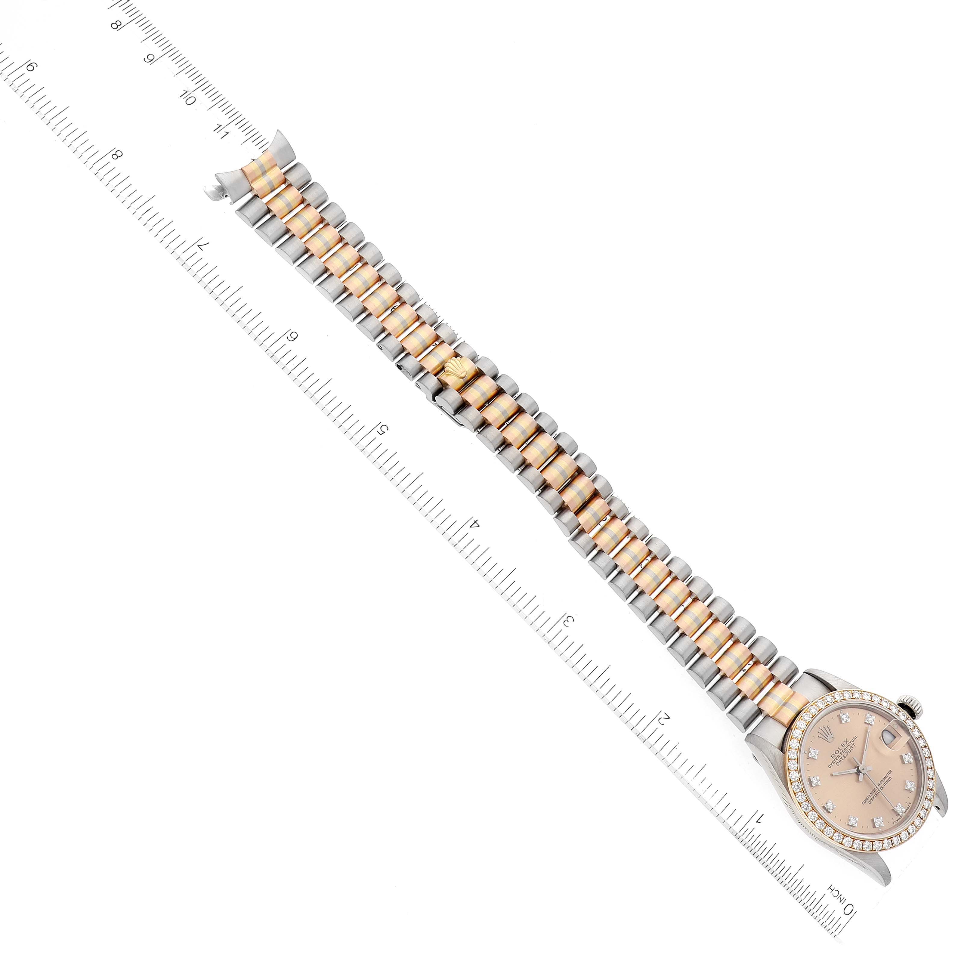 The Rolex President 68289 Women's Steel and Gold (two tone) Brown Dial 68289 Women's Steel and Gold (two tone) Brown Dial model watch is shown from a top-down angle, displaying its face, bezel, and two-tone bracelet alongside a ruler.