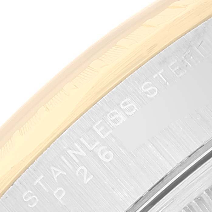 The image shows a close-up of the side of the bezel and the case of a Rolex Date 15223 Men's Steel and Gold (two tone) Black Dial 15223 Men's Steel and Gold (two tone) Black Dial watch, featuring stainless steel and text engraving.