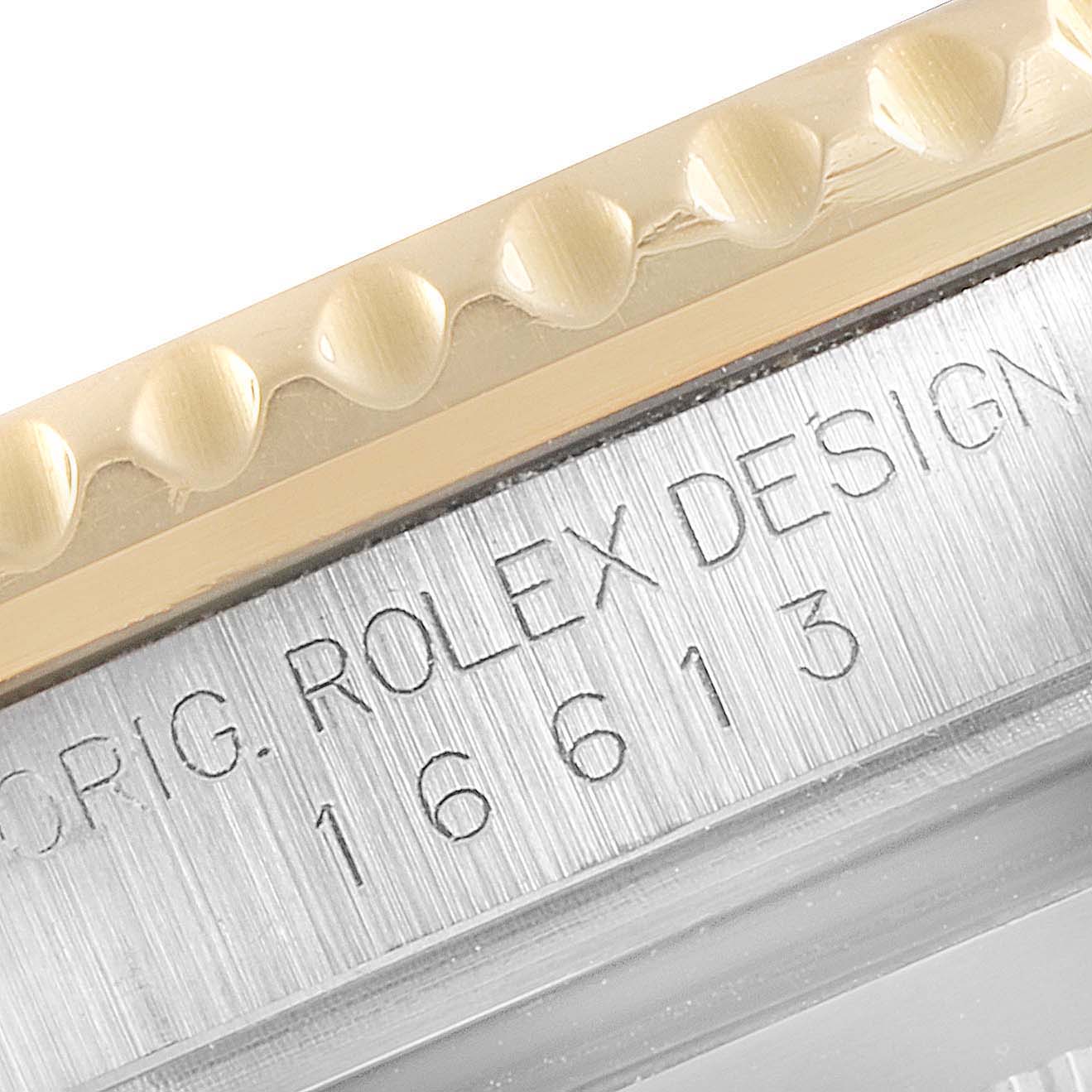 This image shows a close-up of the engraved case side and bezel of a Rolex Submariner 16613 Men's Steel and Gold (two tone) Black Dial 16613 Men's Steel and Gold (two tone) Black Dial watch, model number 16613.