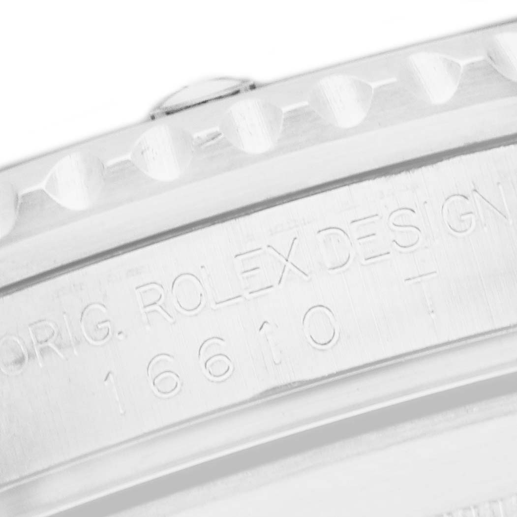 The image shows a close-up of the case back edge of a Rolex Submariner 16610 Men
s Stainless Steel Black Dial 16610 Men
s Stainless Steel Black Dial, including the model number engraving.