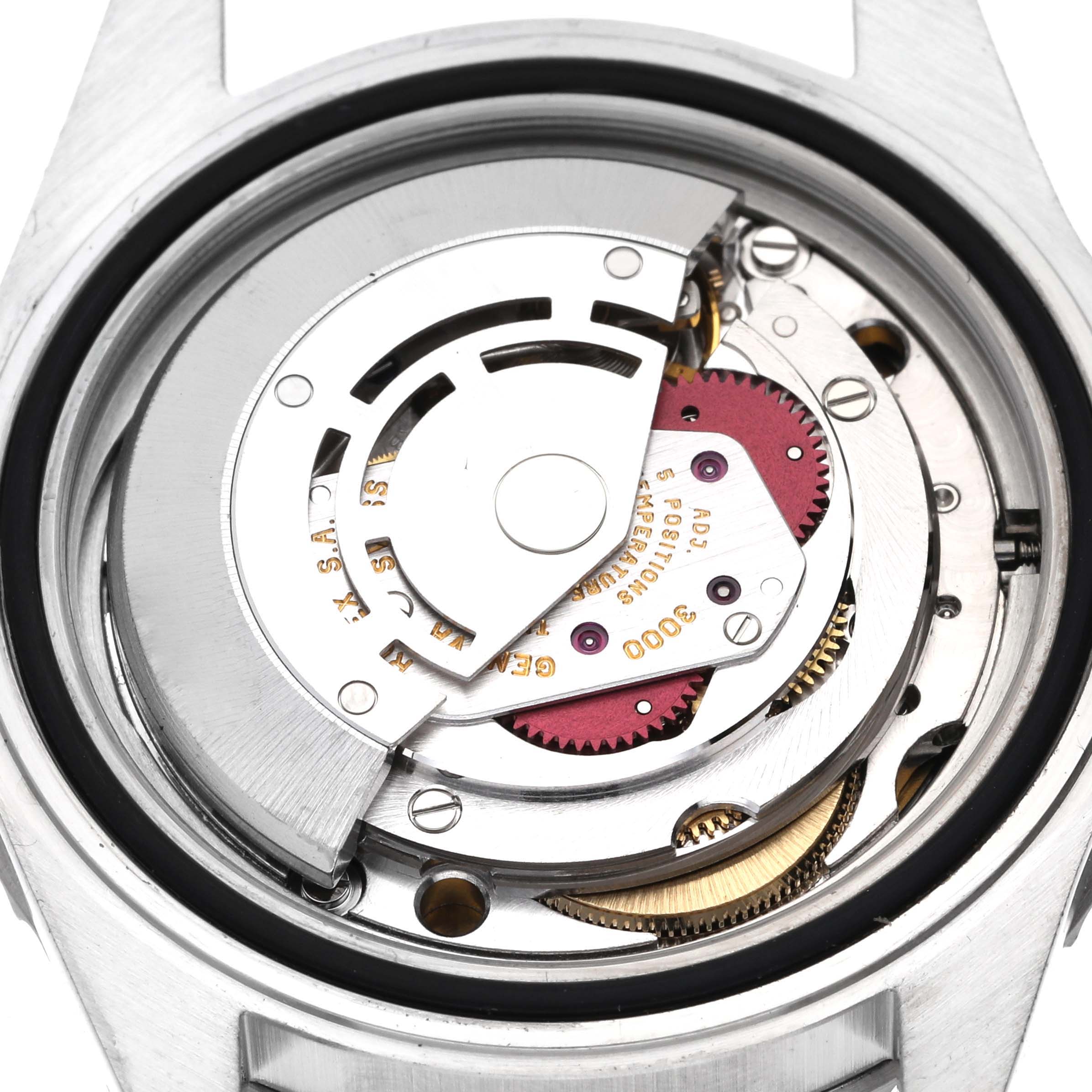 The image shows a close-up view of the movement inside a Rolex Submariner 14060 Men
s Stainless Steel Black Dial 14060 Men
s Stainless Steel Black Dial watch, featuring detailed components like gears and rotors.