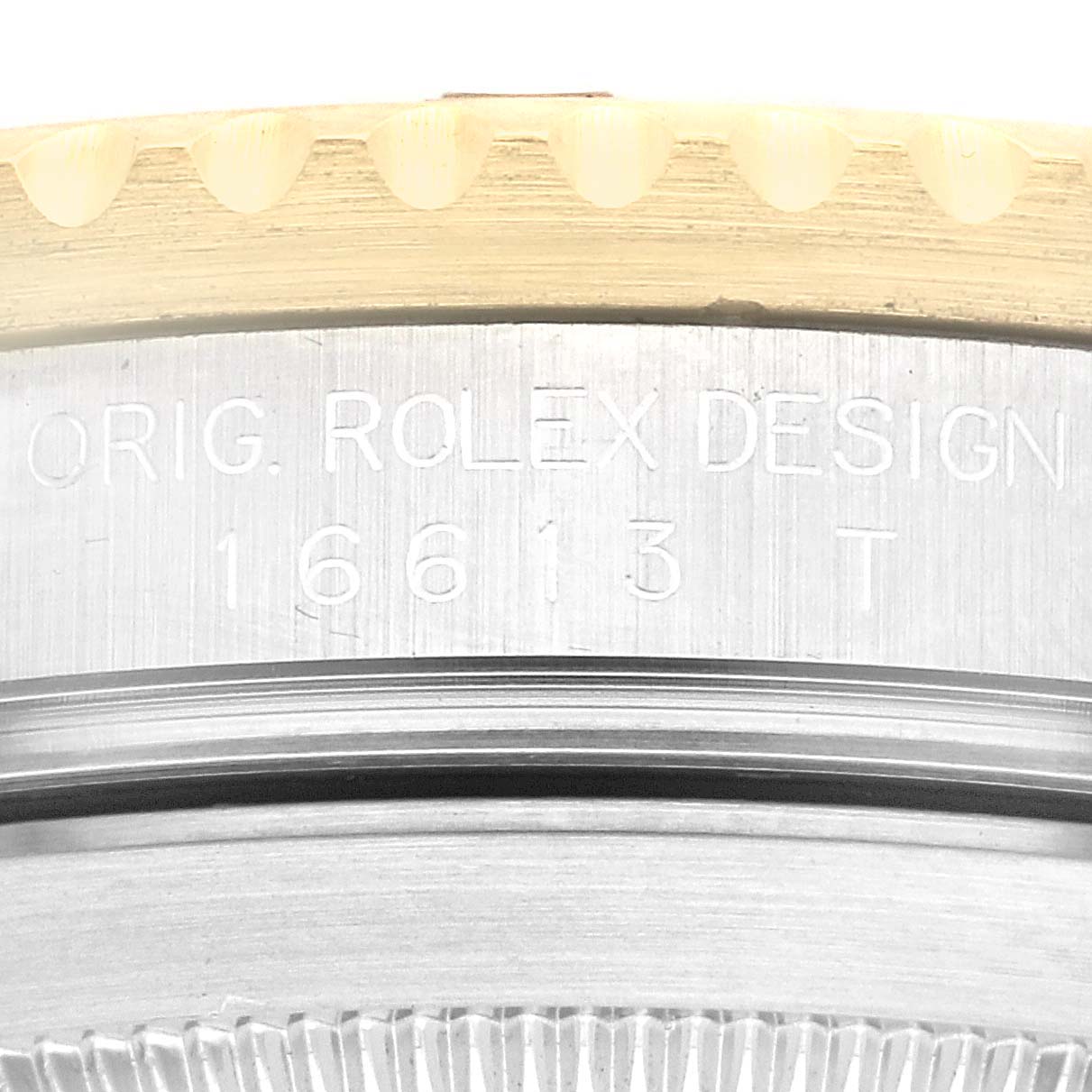 Close-up shot of the case side engraving of a Rolex Submariner 16613 Men's Steel and Gold (two tone) Black Dial 16613 Men's Steel and Gold (two tone) Black Dial, showing the model number and "ORIG. ROLEX DESIGN."
