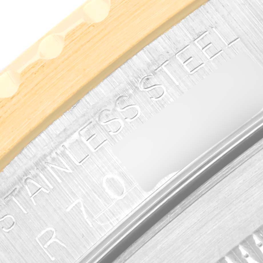 The image shows a close-up of the bezel and case back of a Rolex Submariner 16803 Men's Steel and Gold (two tone) Black Dial 16803 Men's Steel and Gold (two tone) Black Dial, highlighting the "STAINLESS STEEL" engraving.