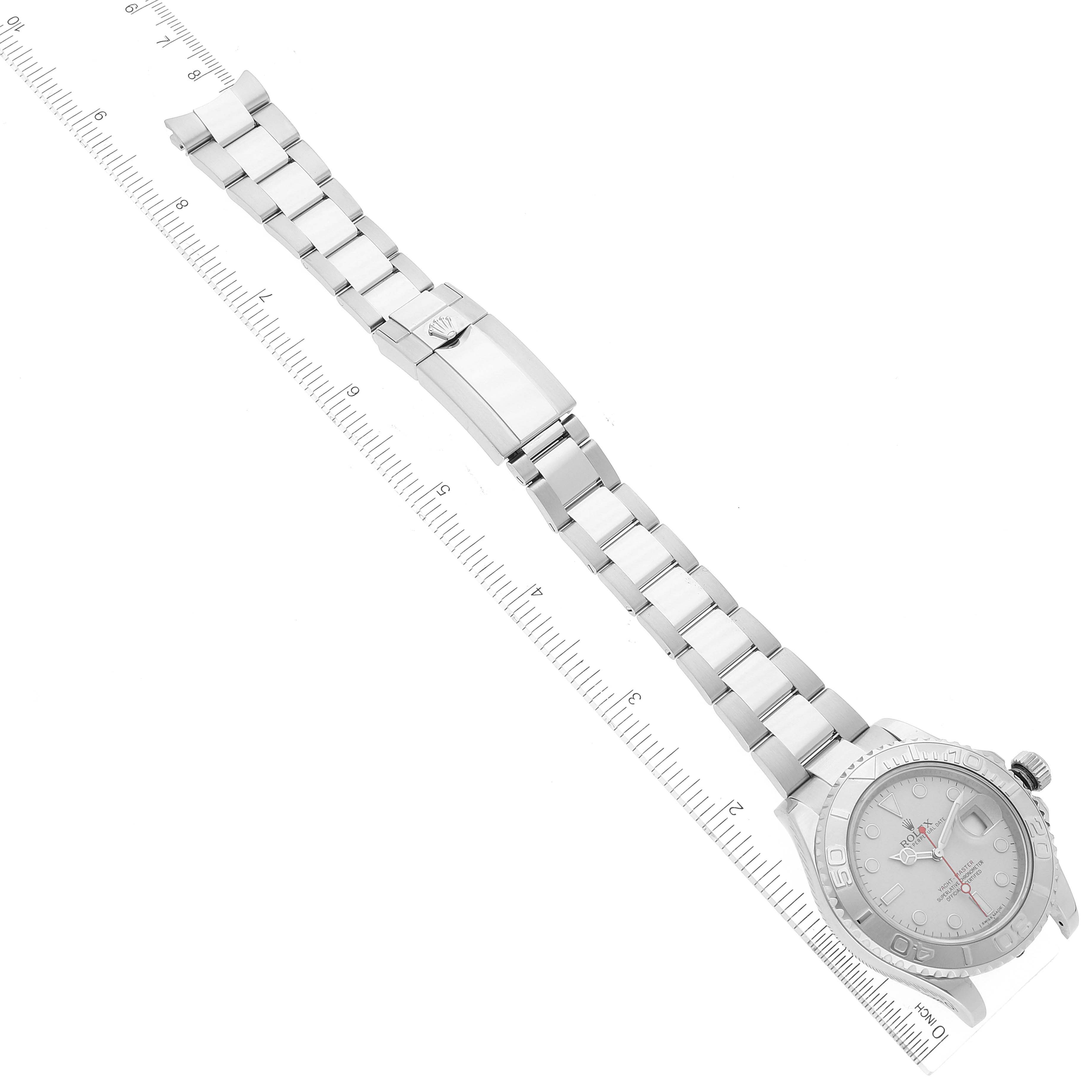 The image shows a full overhead view of a Rolex Yacht-Master 116622 Men
s Stainless Steel Silver Dial 116622 Men
s Stainless Steel Silver Dial watch with its bracelet extended and a measuring ruler beside it.