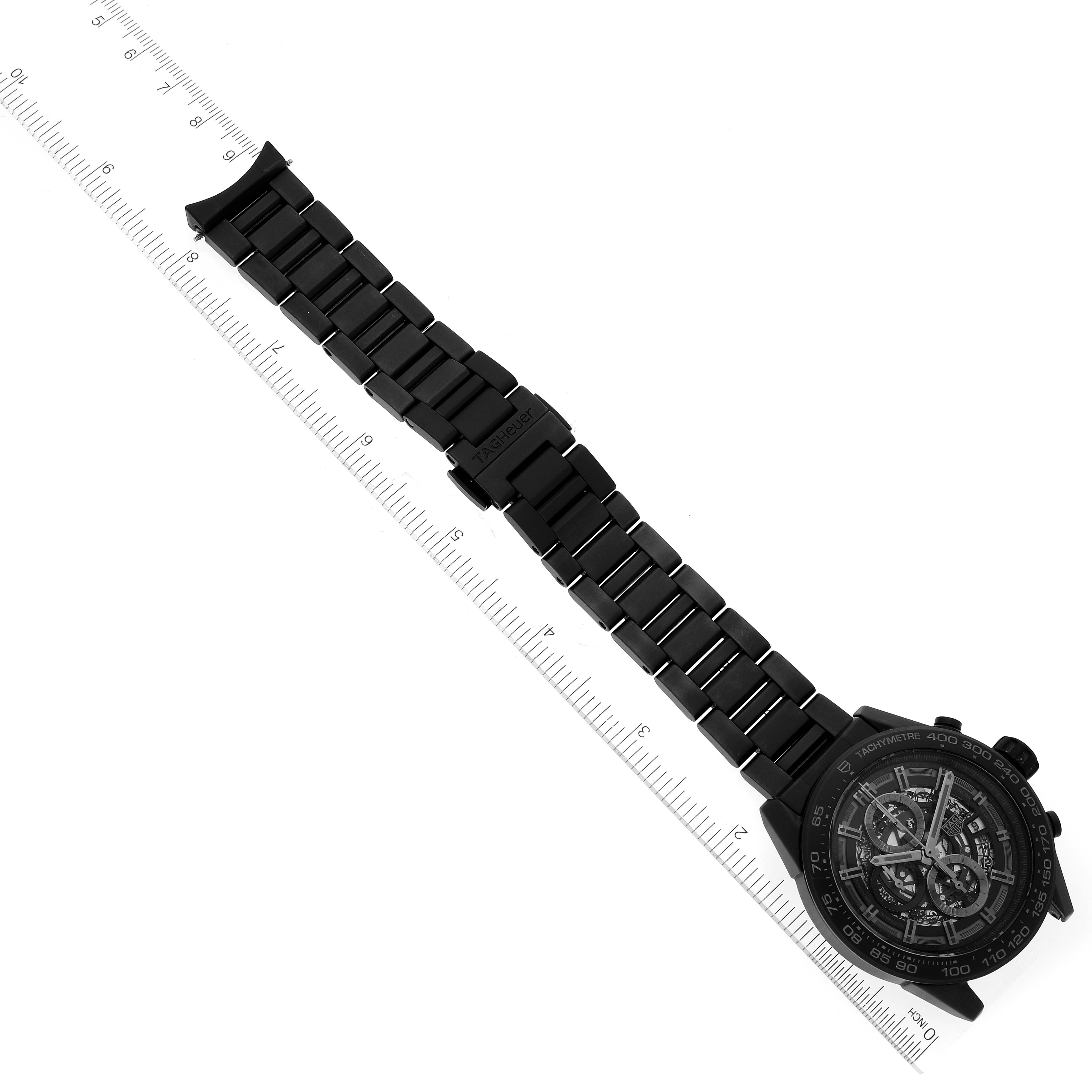 The image shows a Tag Heuer Carrera CAR2A91.BH0742 Men's Ceramic Black Dial CAR2A91.BH0742 Men's Ceramic Black Dial watch from a top-down angle, displaying its face, bezel, and bracelet with a ruler for scale.