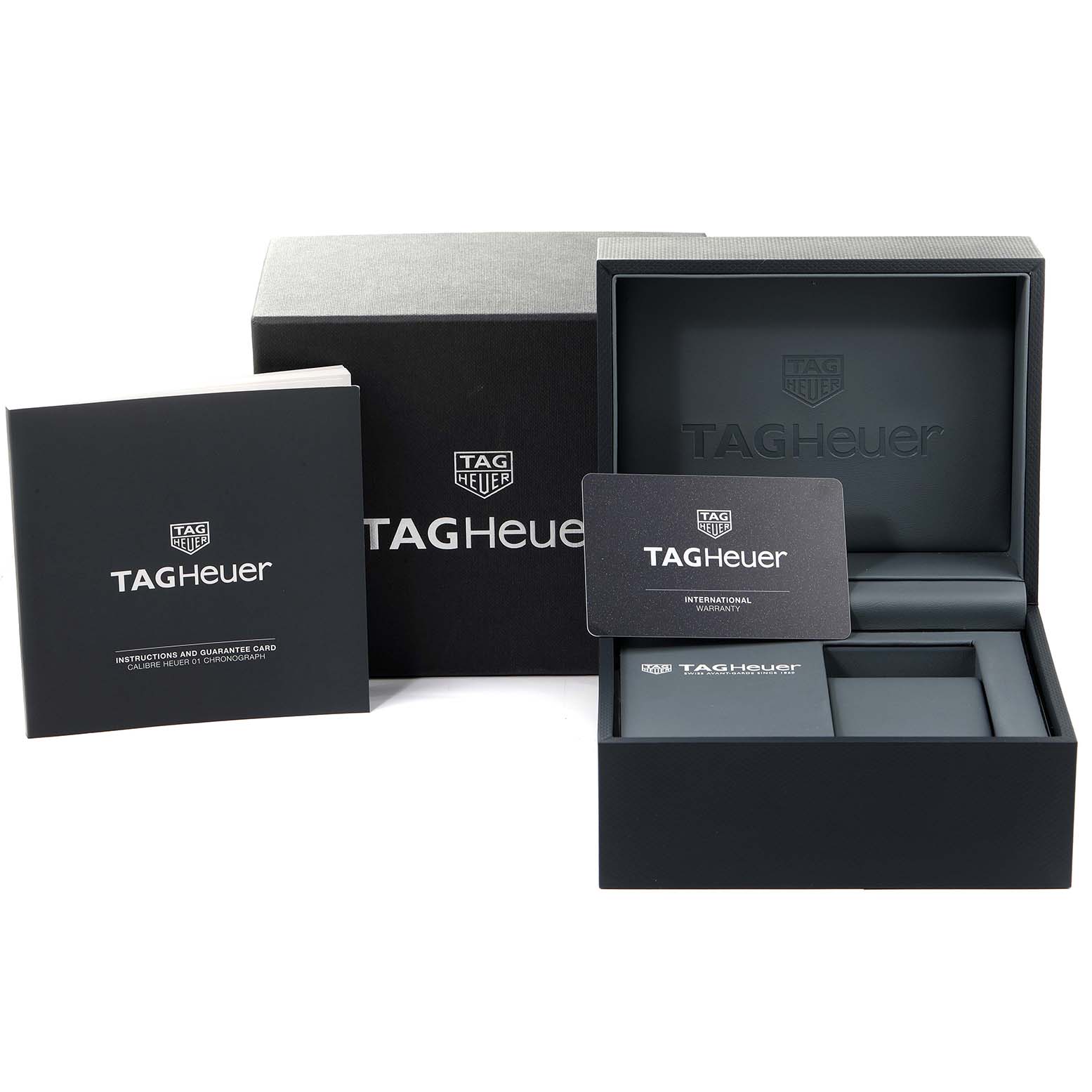 The image shows the packaging, international warranty card, instructions, and the presentation box for the Tag Heuer Carrera CAR2A1H.FT6101 Men's Stainless Steel Black Dial CAR2A1H.FT6101 Men's Stainless Steel Black Dial model.