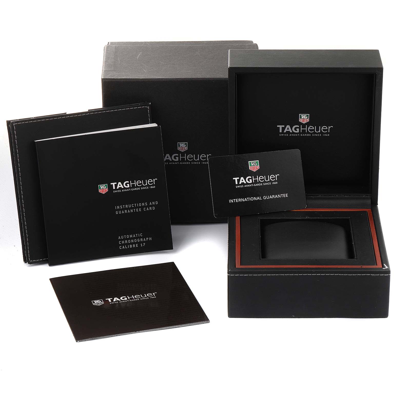 The image shows the packaging, instruction manual, and guarantee cards for a Tag Heuer Monaco CW2111 Men's Stainless Steel Black Dial CW2111 Men's Stainless Steel Black Dial watch.