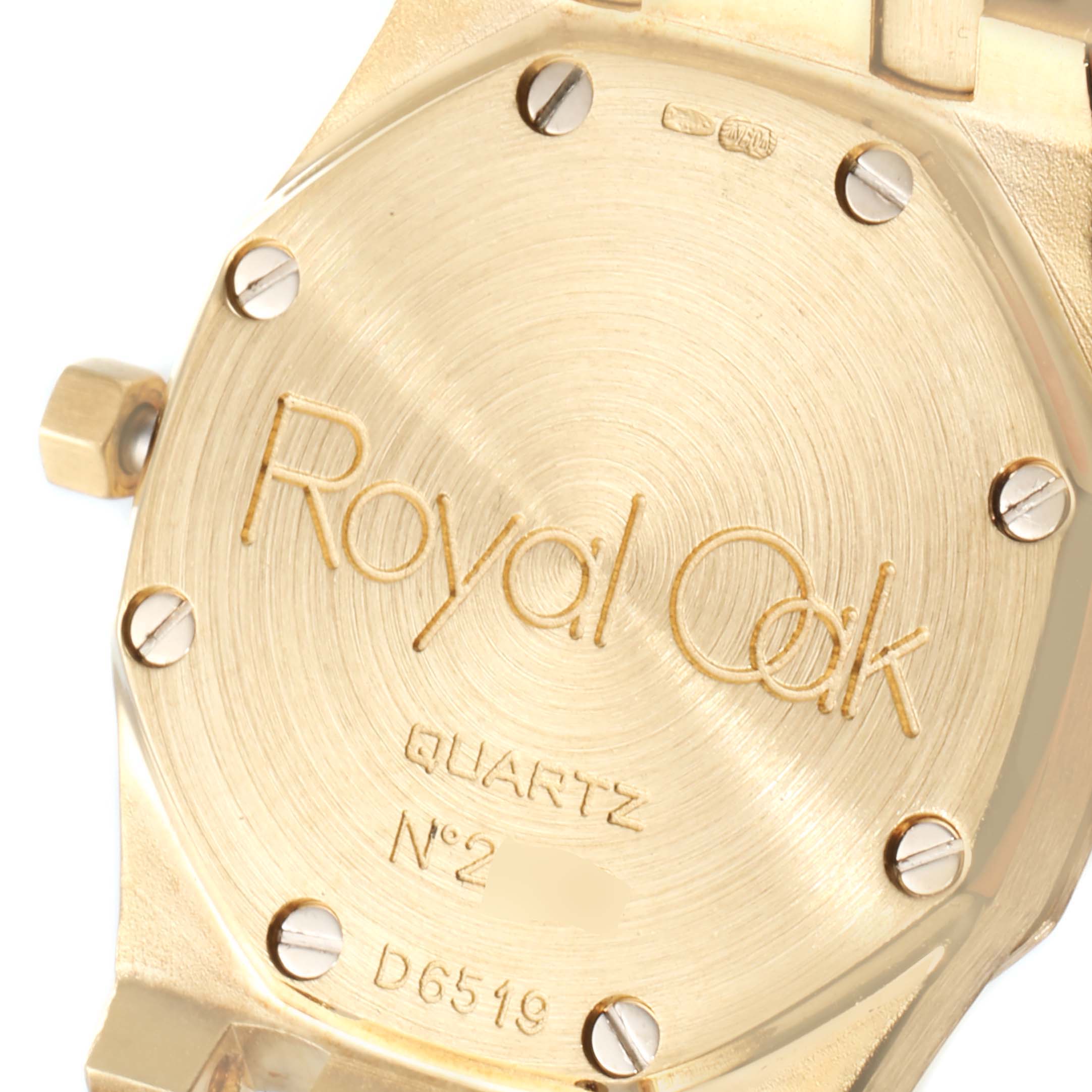 The image shows a close-up of the back case of an Audemars Piguet Royal Oak D6519 Women's Yellow Gold Champagne Dial D6519 Women's Yellow Gold Champagne Dial watch, highlighting the engraved model information.