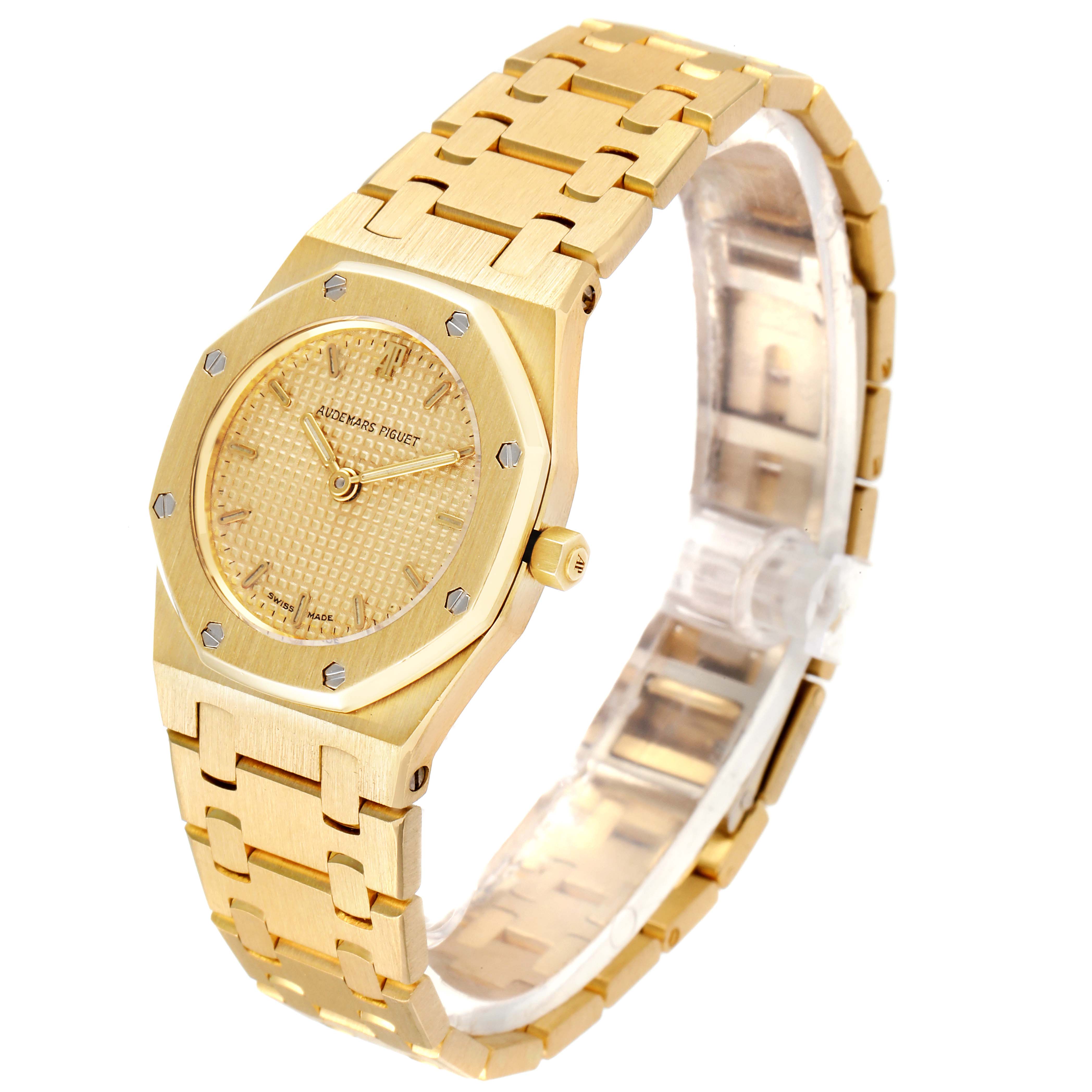 The image shows an angled view of an Audemars Piguet Royal Oak D6519 Women's Yellow Gold Champagne Dial D6519 Women's Yellow Gold Champagne Dial watch, highlighting the gold case, dial, and bracelet.