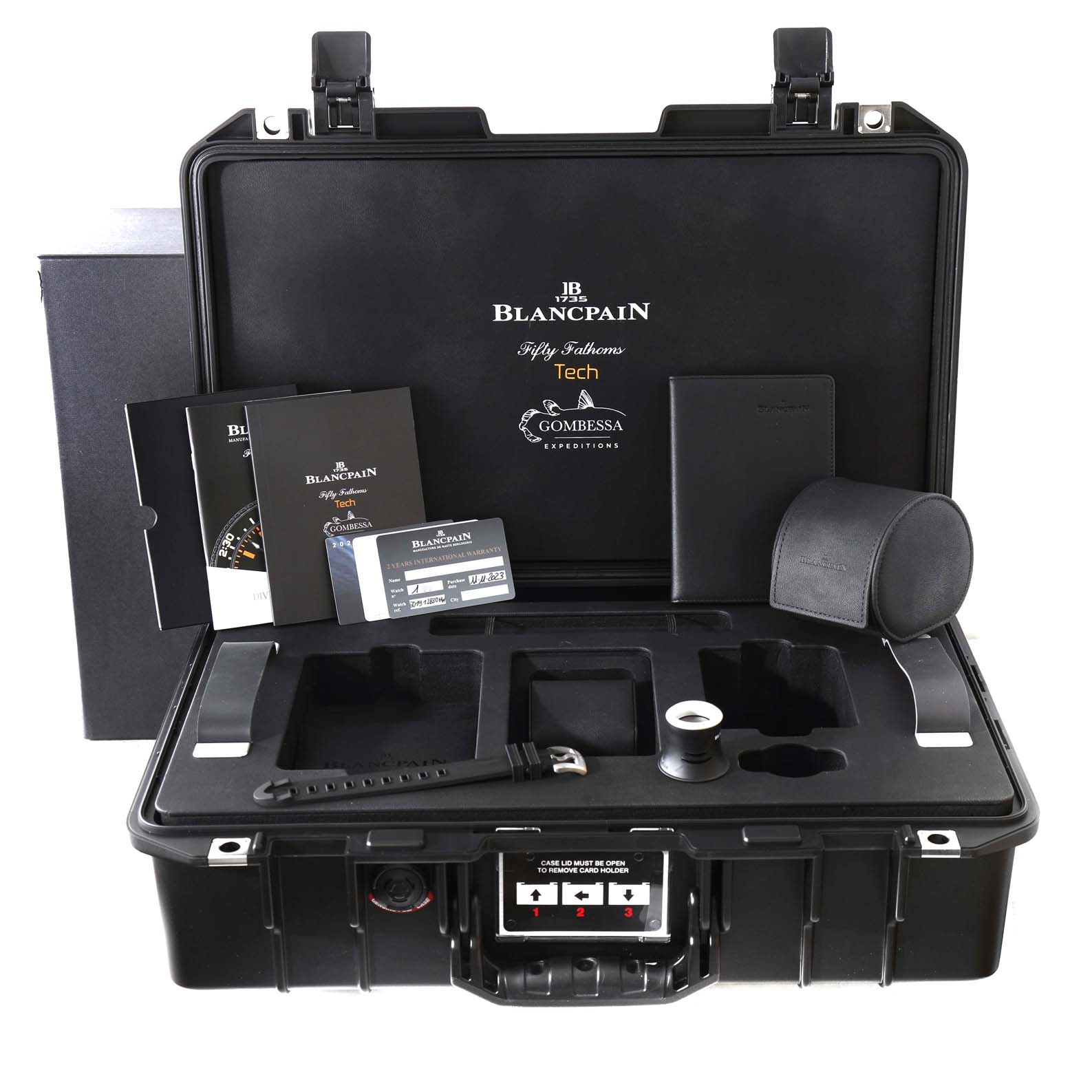 This image shows a top-down view of the Blancpain Fifty Fathoms 5019-12B30-64A Men's Titanium Black Dial 5019-12B30-64A Men's Titanium Black Dial watch packaging, displaying documents, a strap, and accessories.