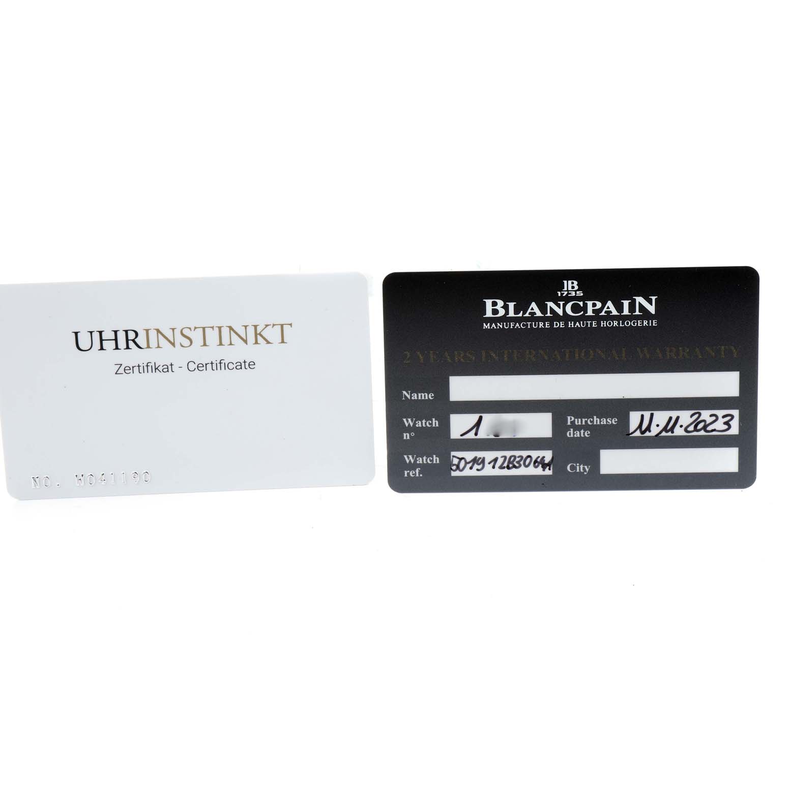 The image shows warranty and certification cards for the Blancpain Fifty Fathoms 5019-12B30-64A Men's Titanium Black Dial 5019-12B30-64A Men's Titanium Black Dial watch.