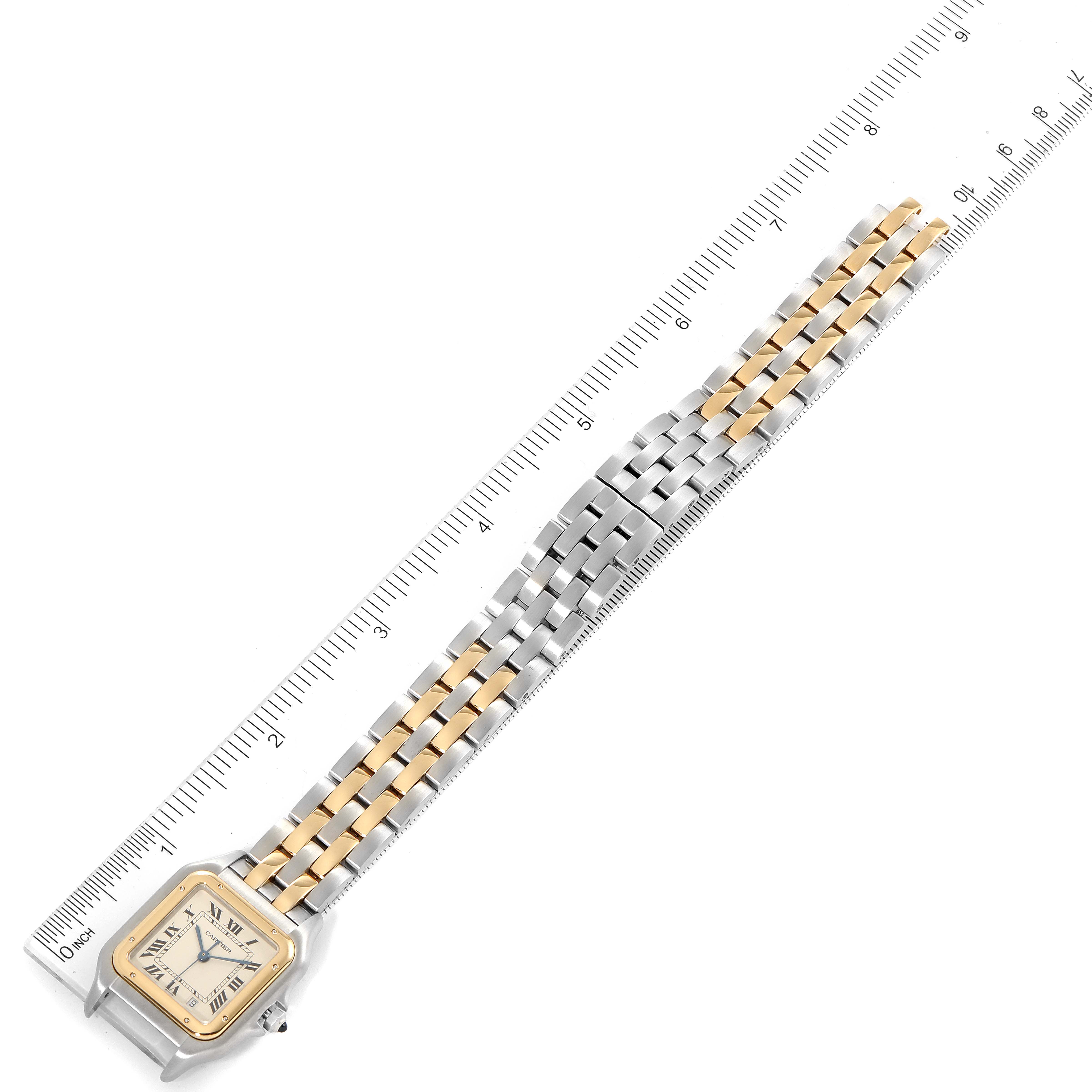 The image shows a top view of the Cartier Panthere W25028B8 Men
s Steel and Gold (two tone) Silver Dial W25028B8 Men
s Steel and Gold (two tone) Silver Dial watch, displaying its dual-tone bracelet and square watch face alongside a measuring ruler.