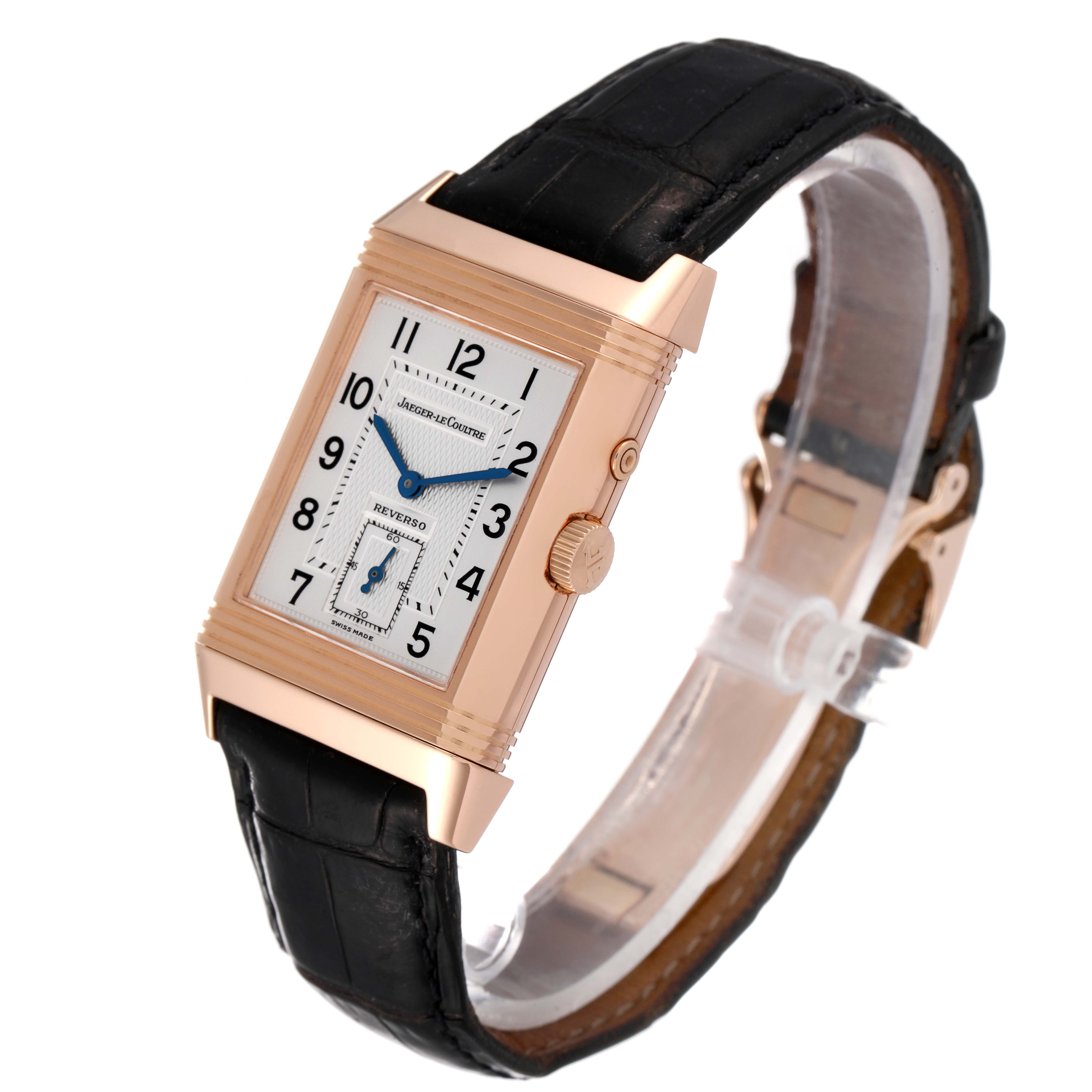 This image shows a Jaeger LeCoultre Reverso Q270254 Men
s Rose Gold Silver Dial Q270254 Men
s Rose Gold Silver Dial watch at a slight angle, highlighting its rectangular face, crown, and black leather strap.
