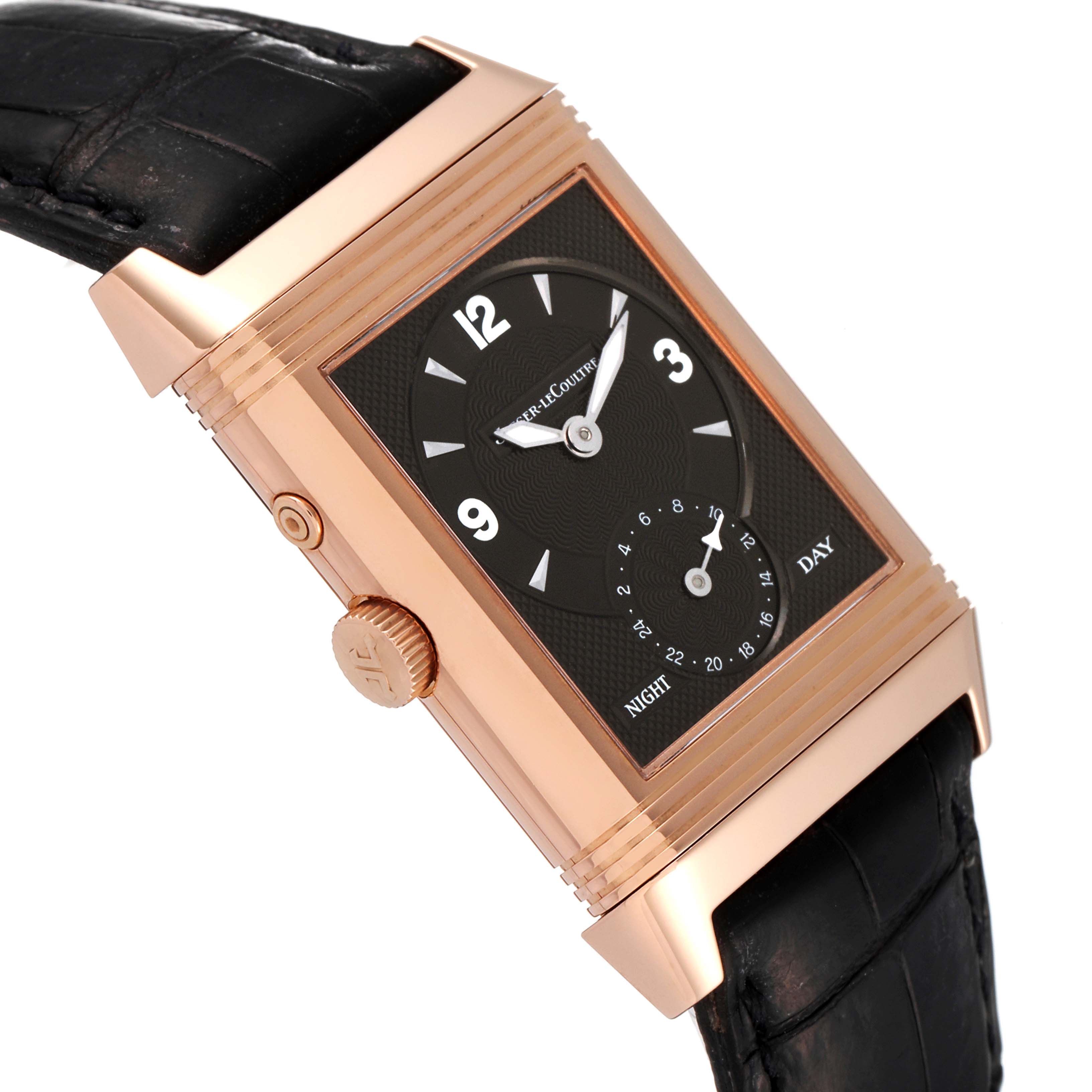 This image shows a Jaeger LeCoultre Reverso Q270254 Men
s Rose Gold Silver Dial Q270254 Men
s Rose Gold Silver Dial watch at an angle, highlighting the crown, side button, and upper strap.