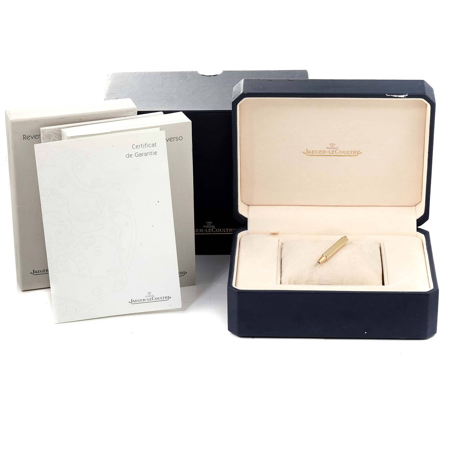 The image shows a Jaeger-LeCoultre Reverso watch box, warranty cards, manuals, and a strap adjustment tool.