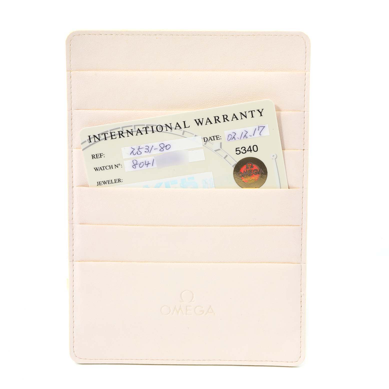 The image shows a beige Omega cardholder with an international warranty card for the Omega Seamaster 2531.80.00 Men
s Stainless Steel Blue Dial 2531.80.00 Men
s Stainless Steel Blue Dial model partially visible.