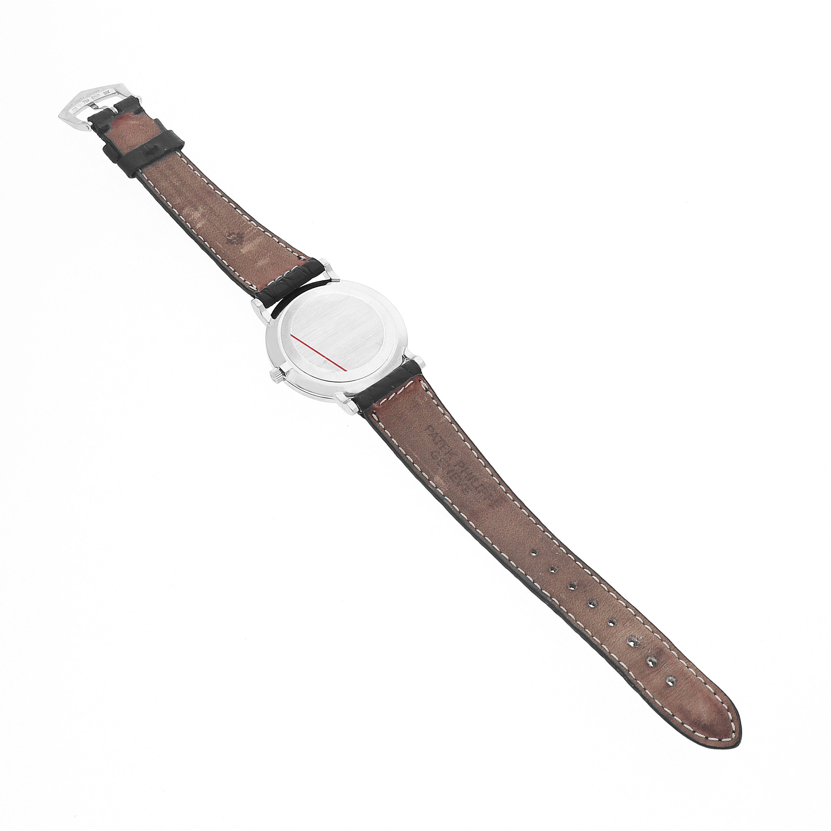 The image shows the back and brown leather strap of a Patek Philippe Calatrava 5022G Men's White Gold Black Dial watch from a top-down angle.