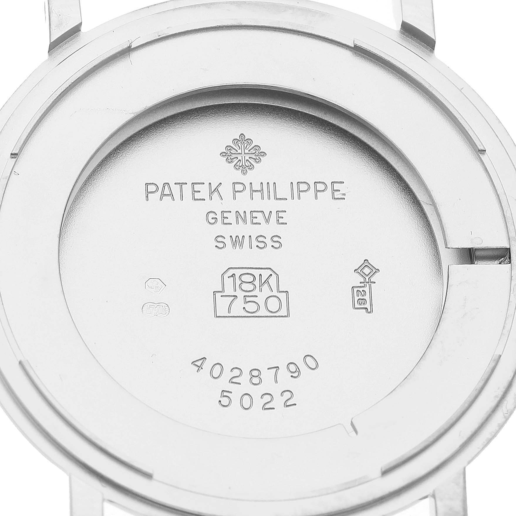 The image shows the back case of a Patek Philippe Calatrava 5022G Men's White Gold Black Dial watch, engraved with hallmarks and model details.
