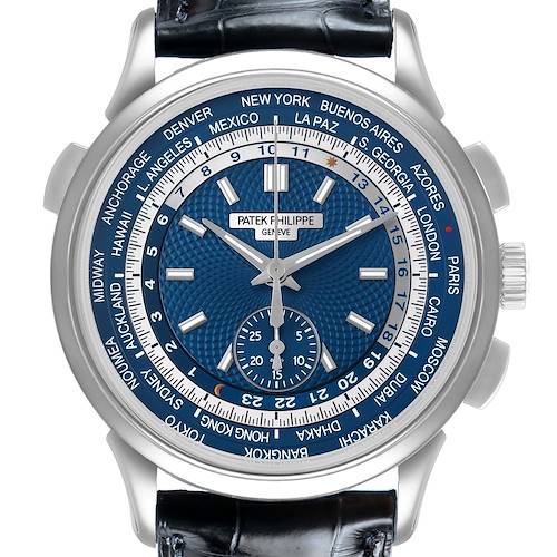 The Patek Philippe Complications 5930G-010 Men's White Gold Blue Dial watch is shown from a front angle, highlighting its blue dial, world time zones, and silver case.