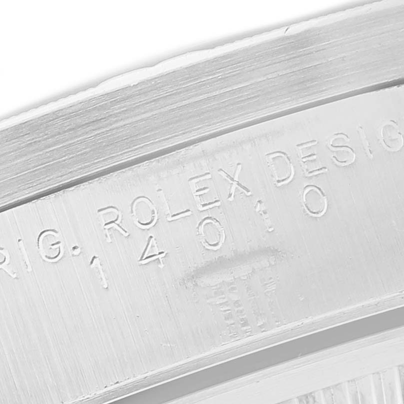 The image shows a close-up of the engravings on the bezel of a Rolex Air-King 14010 Men's Stainless Steel Blue Dial watch.