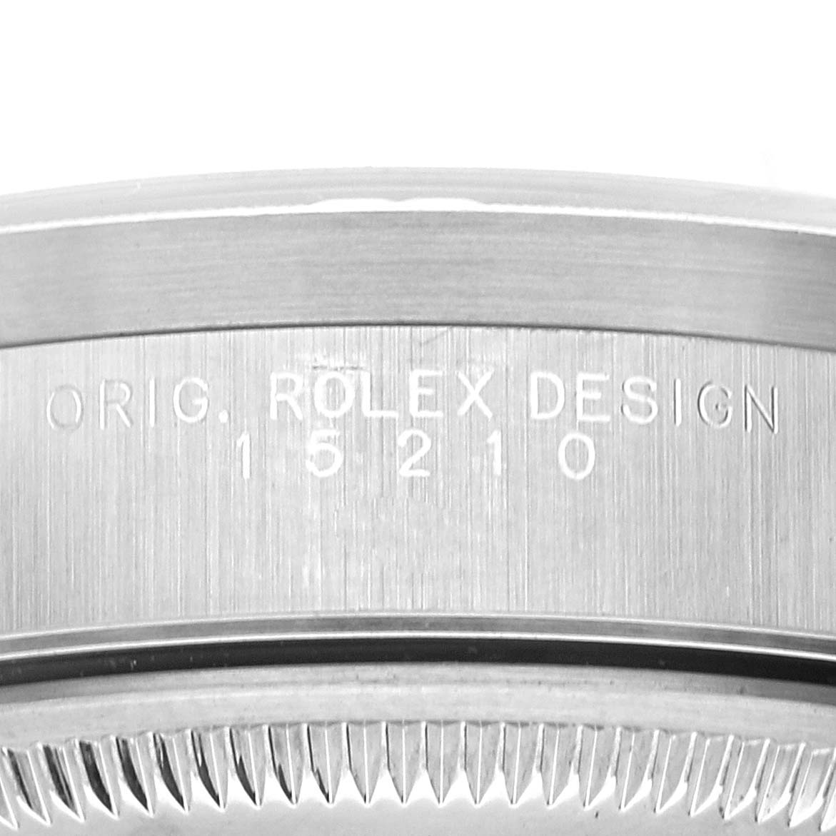 The image shows an engraved side view of the case of a Rolex Date 15210 Men's Stainless Steel Black Dial 15210 Men's Stainless Steel Black Dial model watch, specifically focusing on the model number and "ORIG. ROLEX DESIGN" inscription.