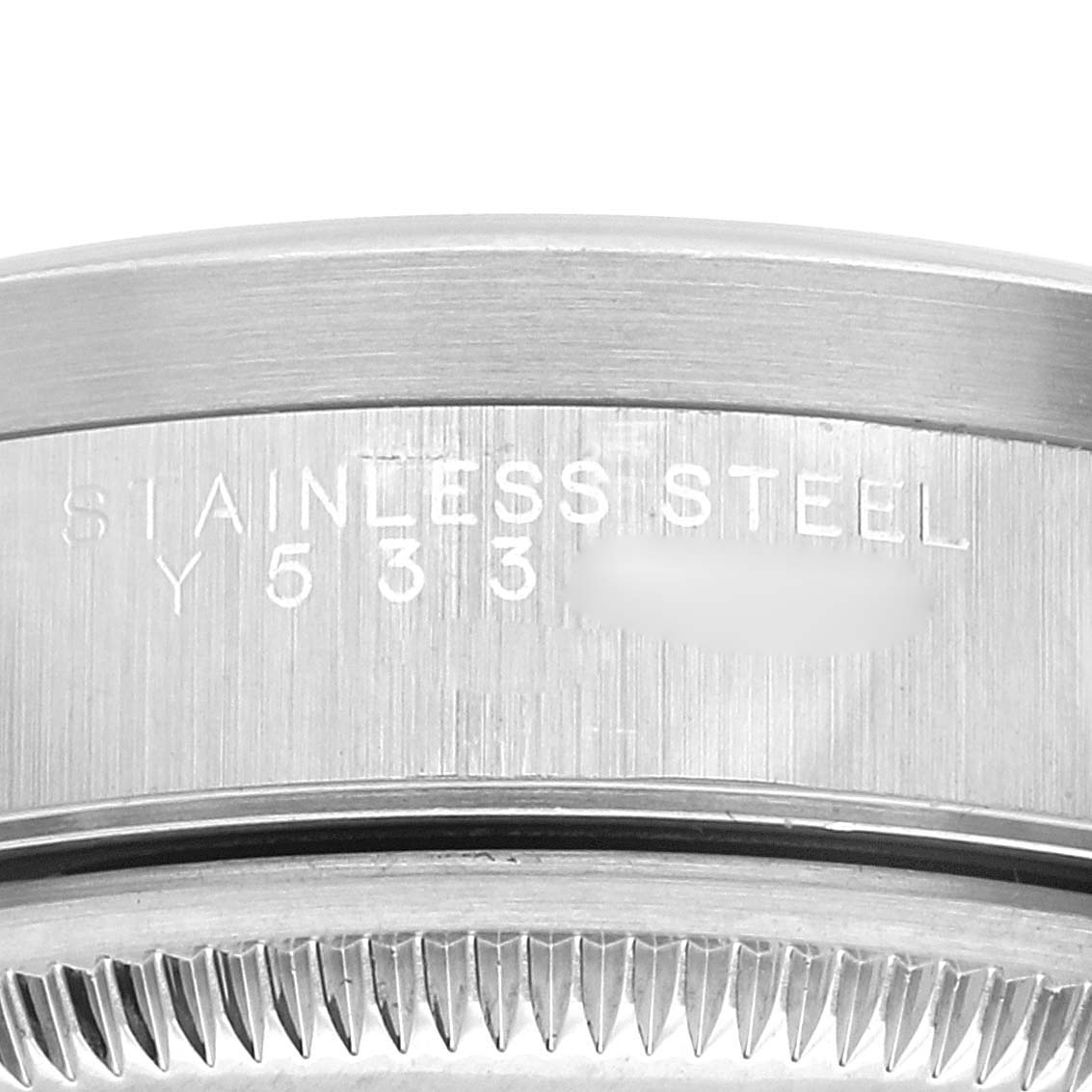 This image shows a close-up of the side of a stainless steel case of a Rolex Date 15210 Men's Stainless Steel Black Dial 15210 Men's Stainless Steel Black Dial model watch, highlighting the serial number and brushed finish.