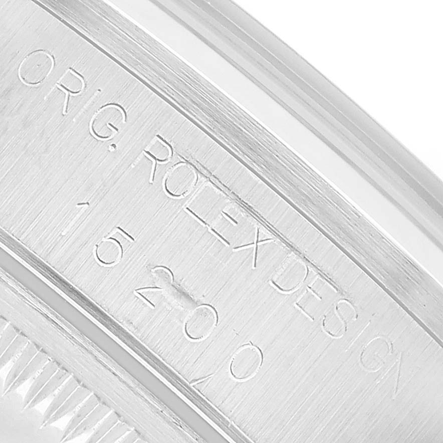 The image shows a close-up of the Rolex Date 15200 Men's Stainless Steel Silver Dial model's inner bezel with engraved design and model number.