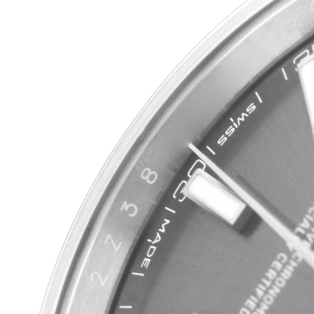 The image shows a close-up of the dial, markers, and part of the bezel of a Rolex Datejust 126300 Men's Stainless Steel Grey Dial watch.