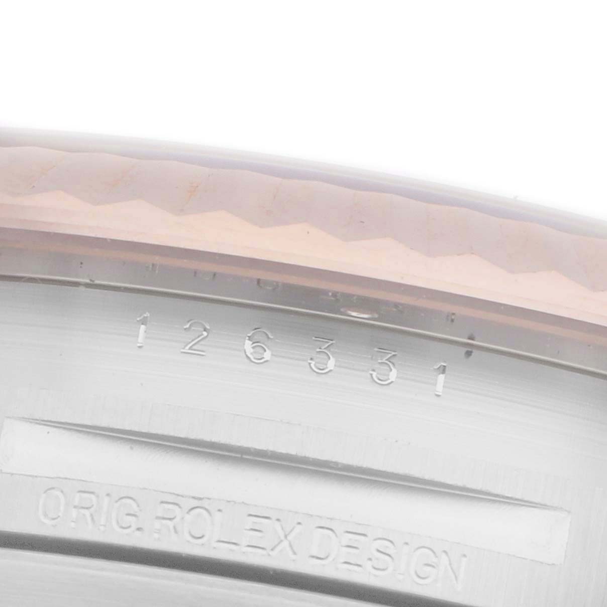 The image shows a close-up view of the model number and "ORIG. ROLEX DESIGN" engraving on the inner bezel of a Rolex Datejust 41 126331 Men's Stainless Steel Grey Dial.