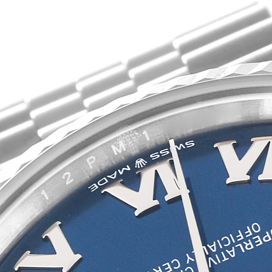The image shows a close-up of a Rolex Mid-Size 278274 Women
s Stainless Steel Blue Dial 278274 Women
s Stainless Steel Blue Dial model watch dial and part of the bracelet from an angle above the 3 o
clock position.