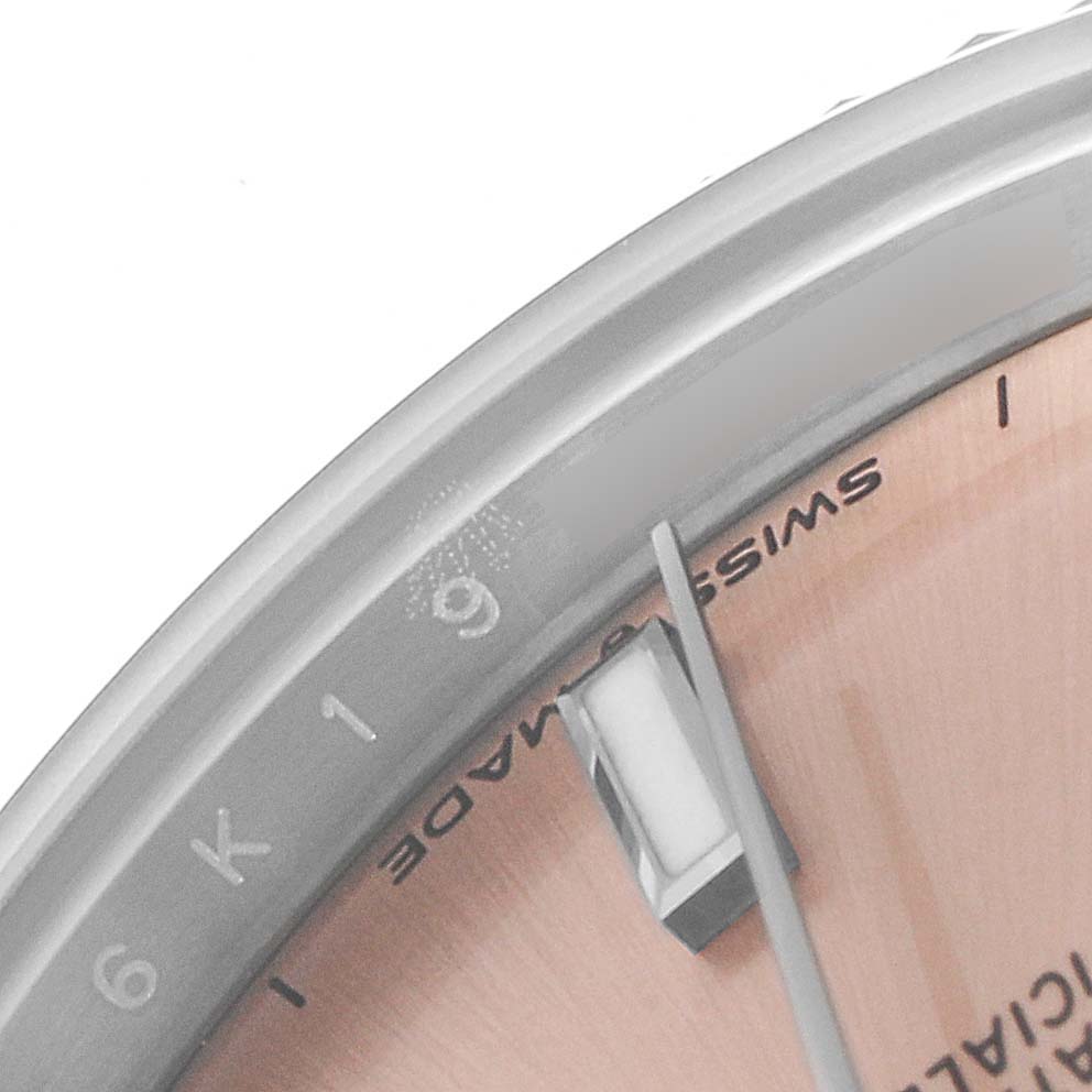 This image shows a close-up of the dial and bezel of a Mid-Size Rolex watch, highlighting the 
Swiss Made
 text.