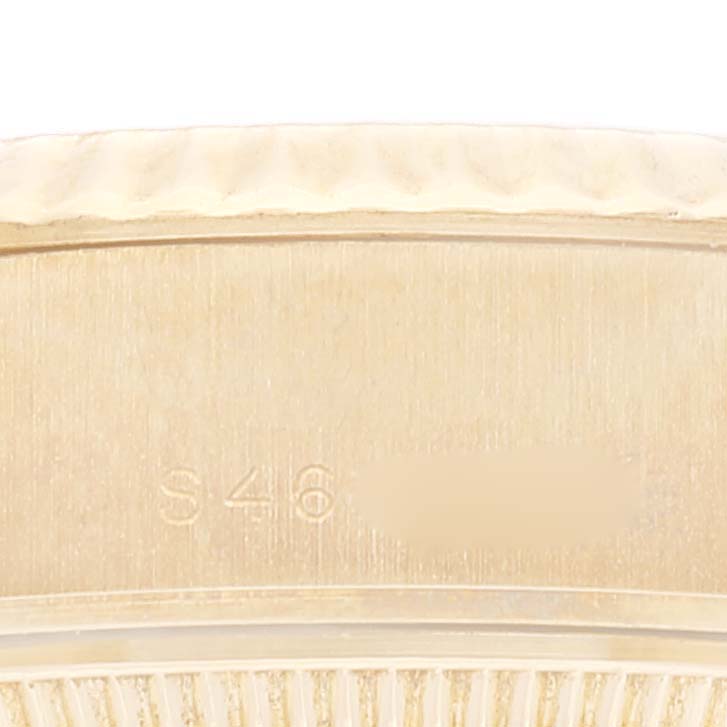 This is a close-up view of the side of a Rolex President 69178 Women's Yellow Gold Champagne Dial 69178 Women's Yellow Gold Champagne Dial model watch, showing part of the bezel and case with an engraving.