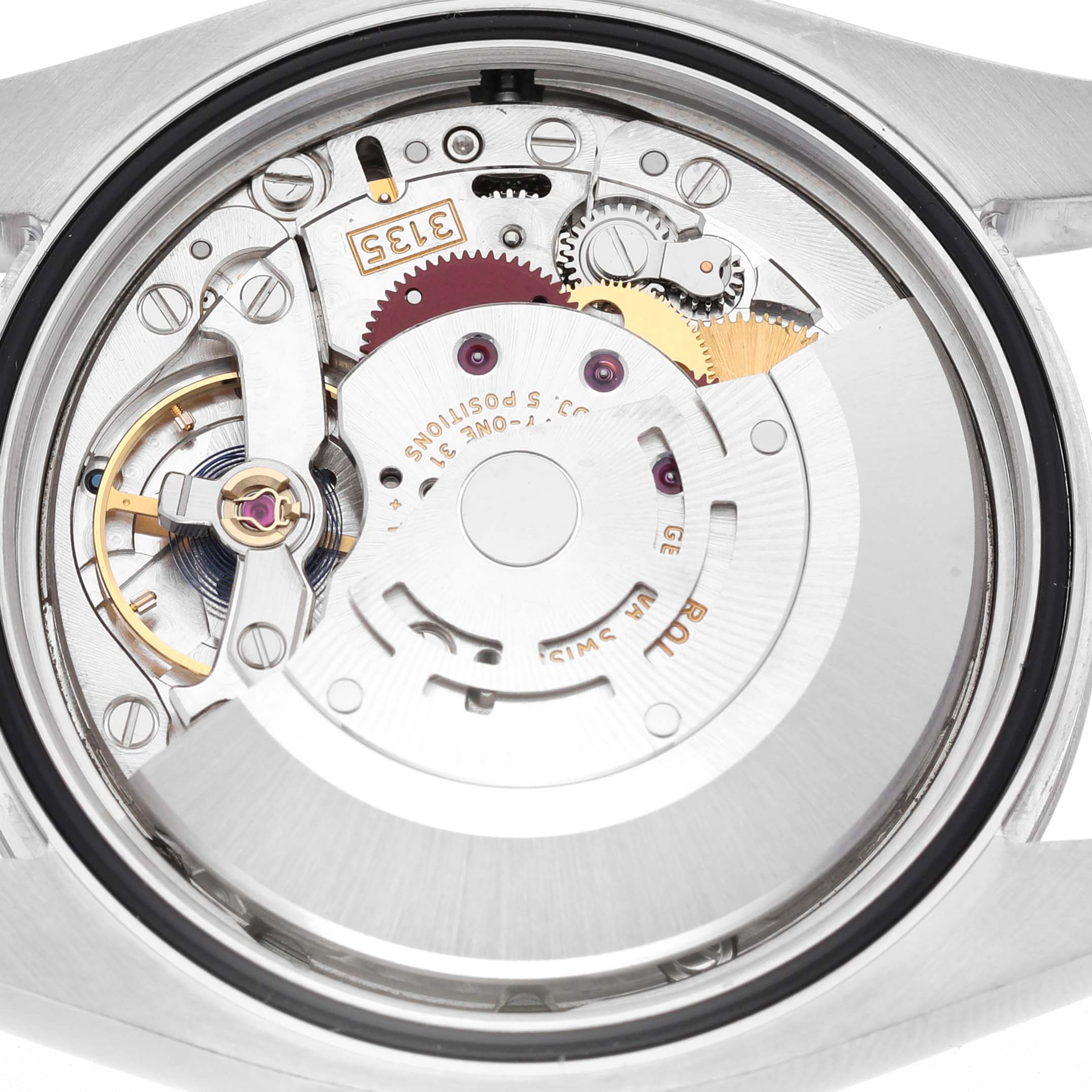 The image shows the movement of a Rolex Datejust 116200 Men's Stainless Steel Silver Dial watch from the back, highlighting the intricate mechanical parts.