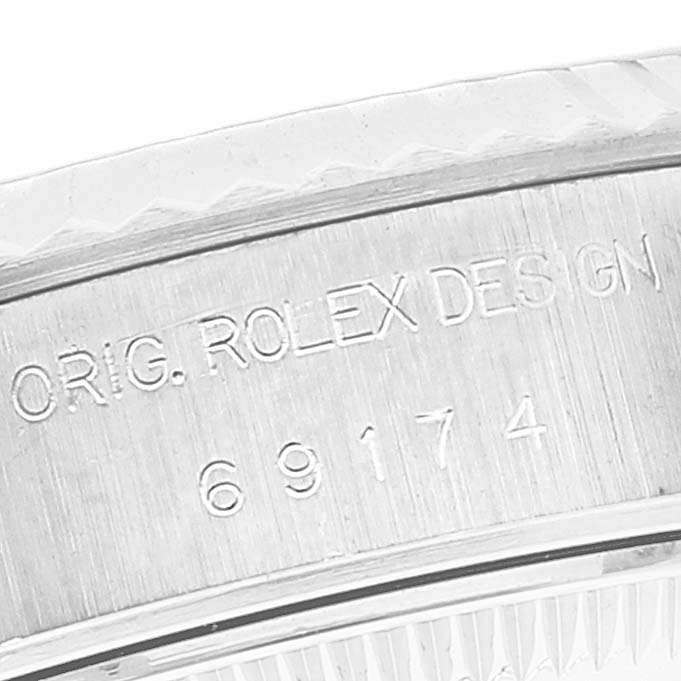 This close-up image shows the engraved reference number and "ORIG. ROLEX DESIGN" on the case back of a Rolex Datejust 69174 Women's Stainless Steel Mother of Pearl Dial 69174 Women's Stainless Steel Mother of Pearl Dial watch.