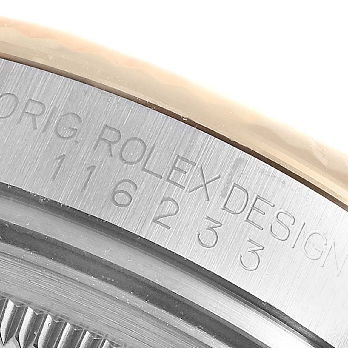 The image shows a close-up of the side of the Rolex Datejust 116233 Men's Steel and Gold (two tone) Champagne Dial 116233 Men's Steel and Gold (two tone) Champagne Dial watch case, highlighting the engraved model number.