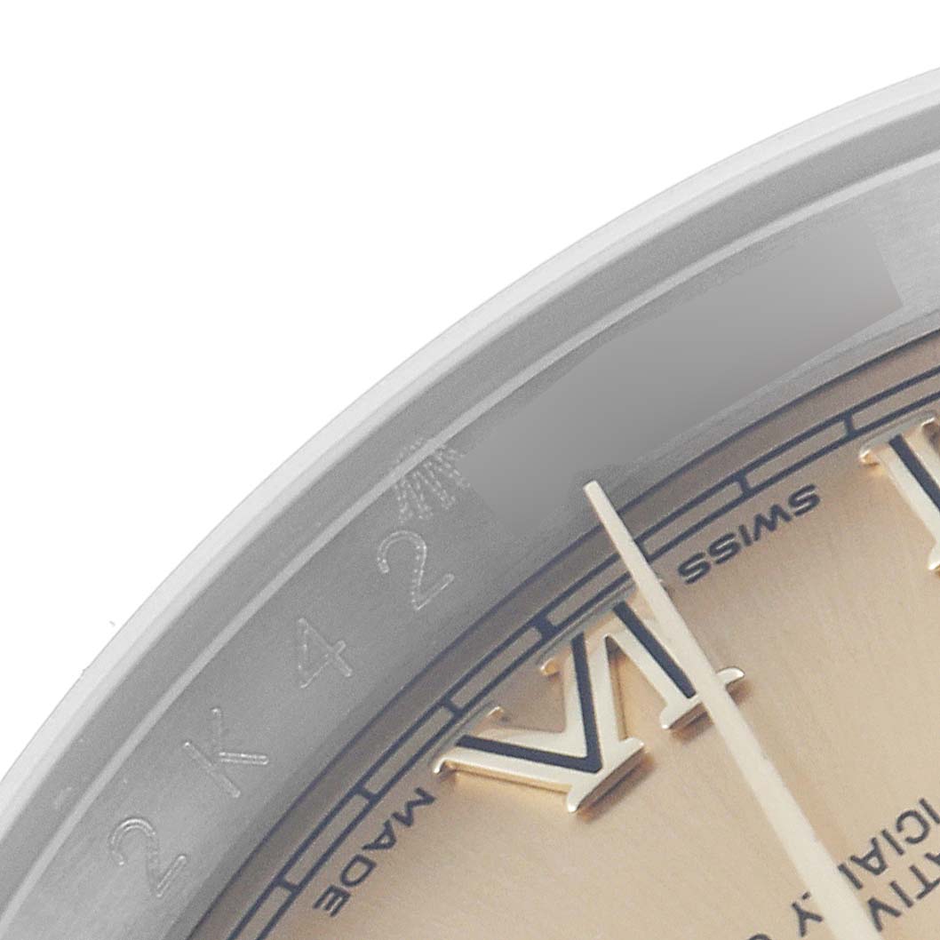 This close-up image shows a portion of the dial and bezel of a Rolex Datejust 116233 Men's Steel and Gold (two tone) Champagne Dial 116233 Men's Steel and Gold (two tone) Champagne Dial watch, including the Roman numeral VI.