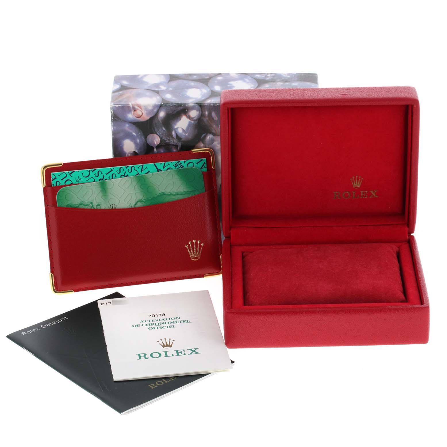 This image shows the Rolex Datejust 79173 Women
s Steel and Gold (two tone) Mother of Pearl Dial 79173 Women
s Steel and Gold (two tone) Mother of Pearl Dial model
s box, cardholder, and manuals from a straight-on angle.