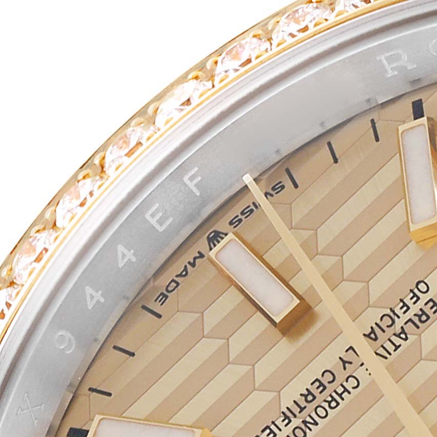 This image shows a close-up of the face, bezel, and part of the dial of a Rolex Datejust 126283 Men's Steel and Gold (two tone) Champagne Dial 126283 Men's Steel and Gold (two tone) Champagne Dial watch.